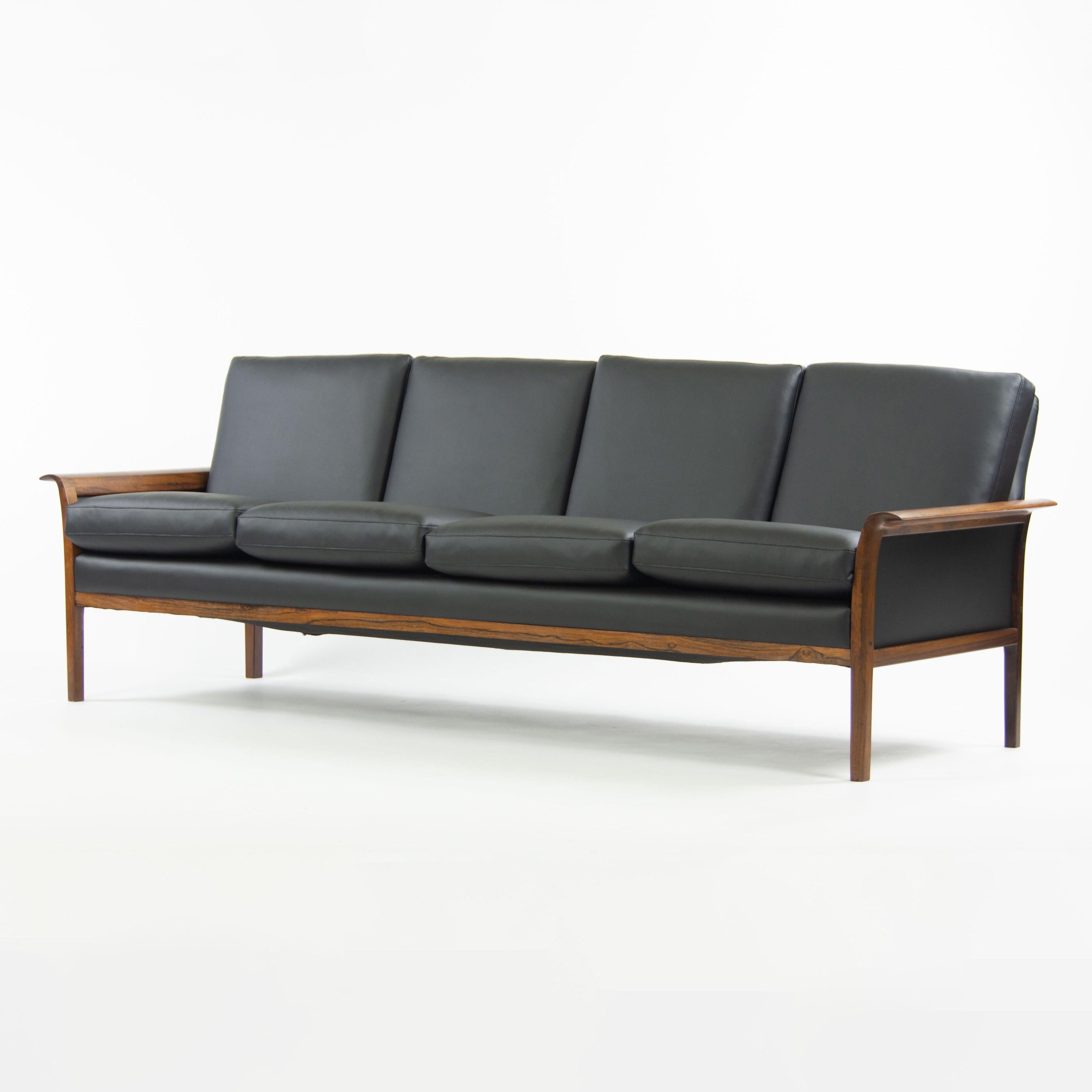 Listed for sale is a gorgeous and authentic Knut Saeter rosewood sofa, produced by Vatne Mobler. This example has just been freshly reupholstered at a cost of well over $2500. The upholstery is stunning, contrasting nicely with the rosewood frame.