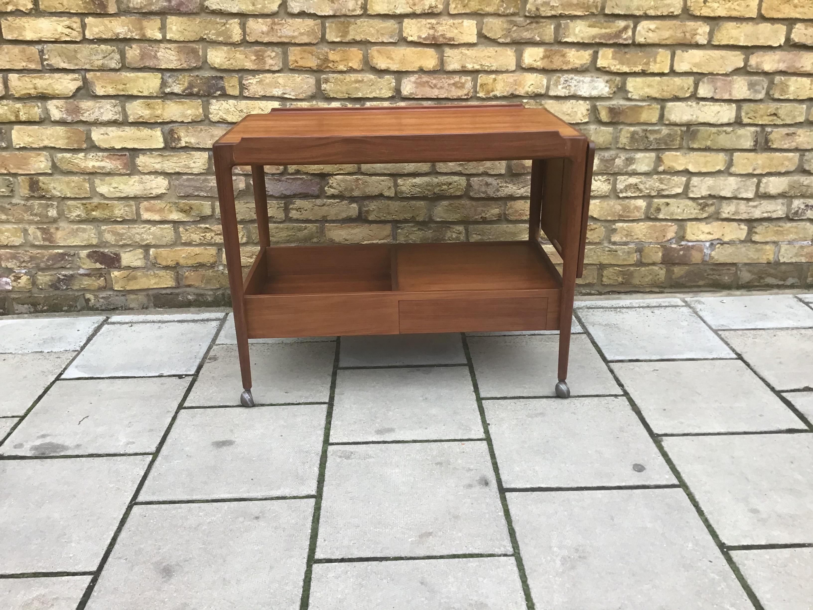 stunning 1960s G-plan tea trolley which was designed by the Danish designer, Kofod Larsen. He produced G-plans Danish range during the 1960s and the tea trolley is one of the rarer items that is on the market. The trolley is in good condition for