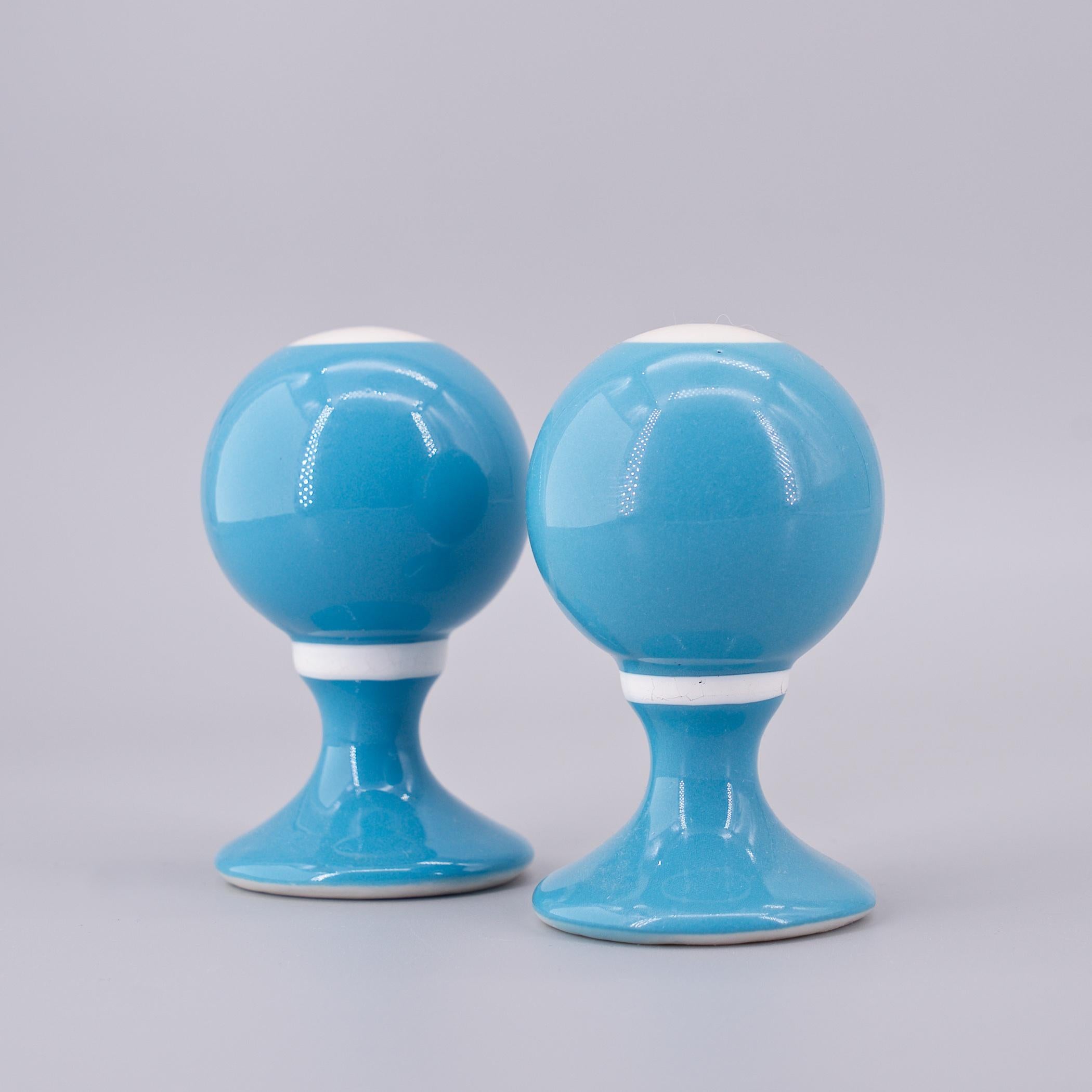 Alexander Girard for Mayer China / Minners. Made in the 1960s. Bollard-form salt shakers. Identical each with single hole. No chips, no cracks. Some crazing to the white bands around the neck.
