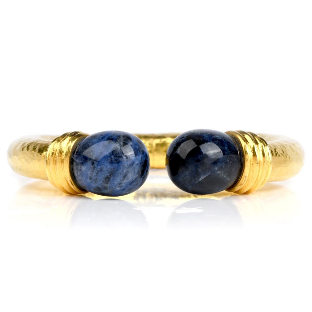 Embrace your inner Grecian goddess with this  vintage LALAOUNIS Sodalite 22K Gold Textured Cuff Bracelet! 

This bracelet is crafted in quality textured 22 karat yellow gold.  It displays two large sodalite cabochons of natural shape.  The hinge is