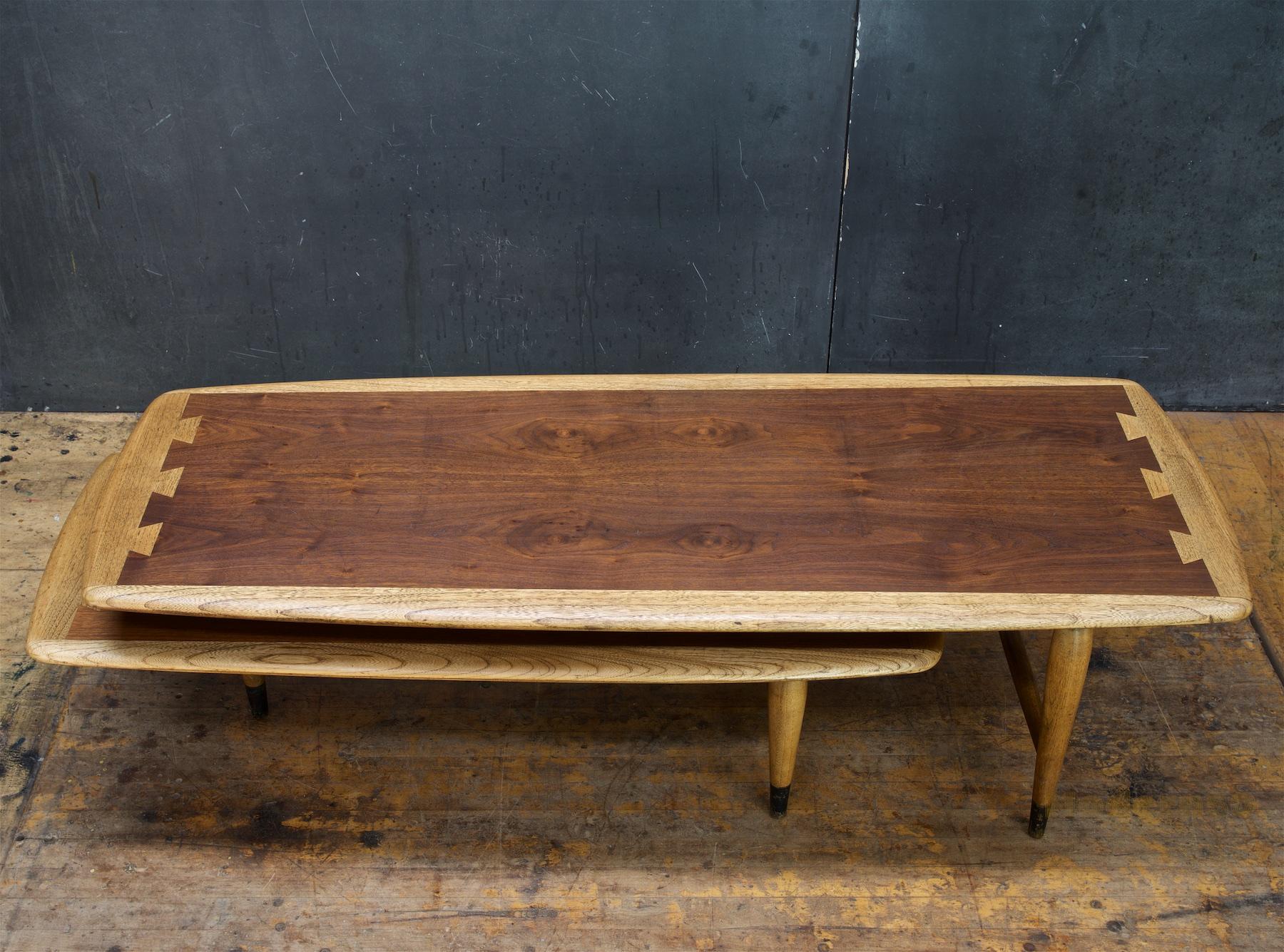 A super midcentury vibe, this table designed by Andre Bus is quickly becoming an icon of the MCM bygone Era! It is getting harder and harder to find the acclaim design series in this double-coffee table 'switchblade' form. Total width opened all the