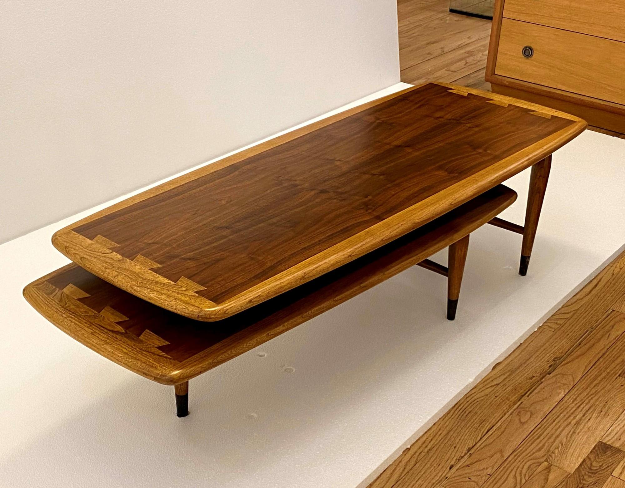 1960s Mid-Century Modern Lane Switchblade coffee table. From their highly successful Acclaim series designed by Andre Bus, this adjustable two-piece table is made out of dark tone walnut and light tone hickory woods with an interlocking dovetail