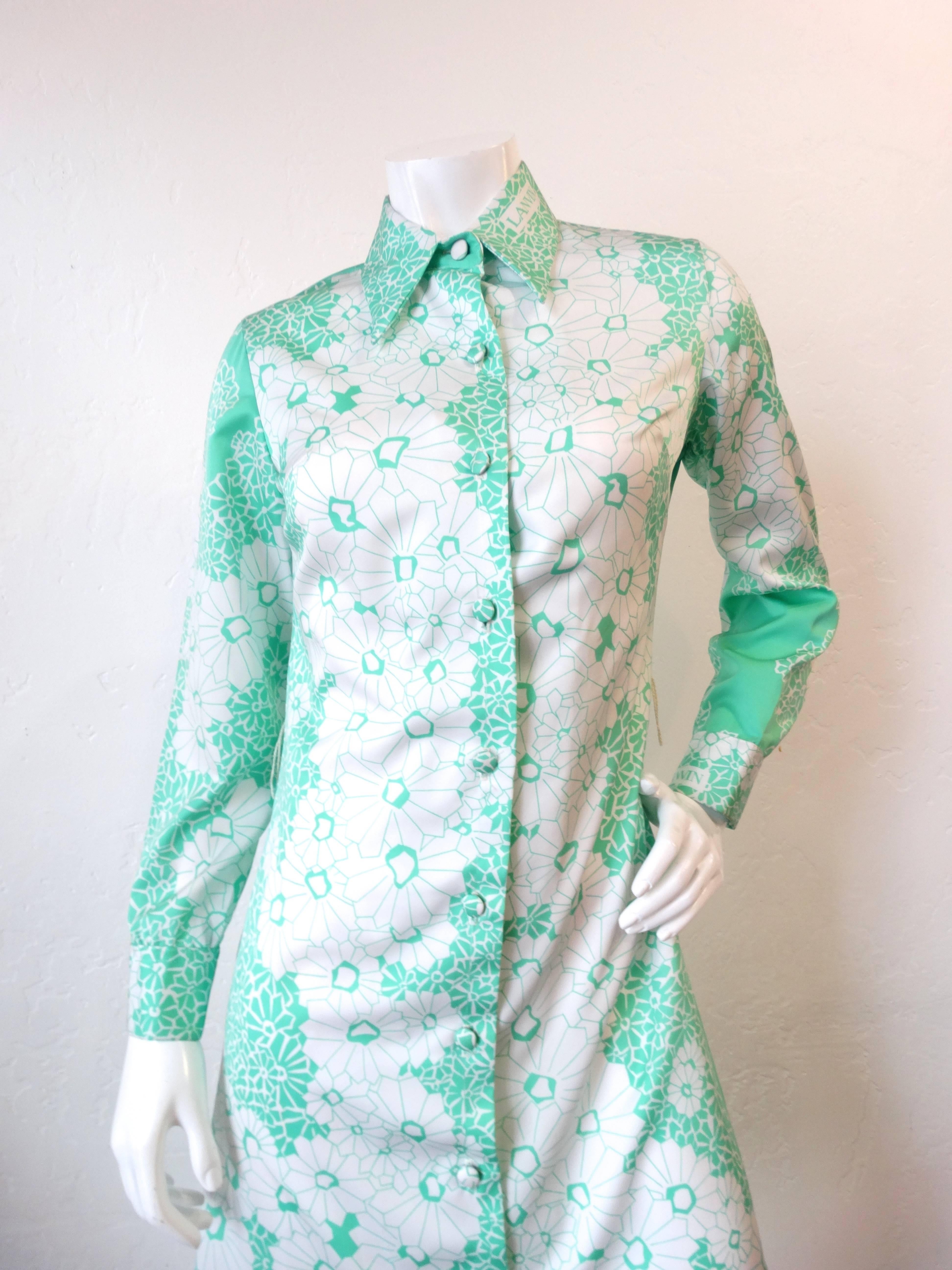 The most darling 1960s dress from iconic designer Lanvin! Covered in a flattering all over floral print in a gorgeous shade of mint and white! Matching cloth covered buttons up the front. Our favorite part of this piece? 