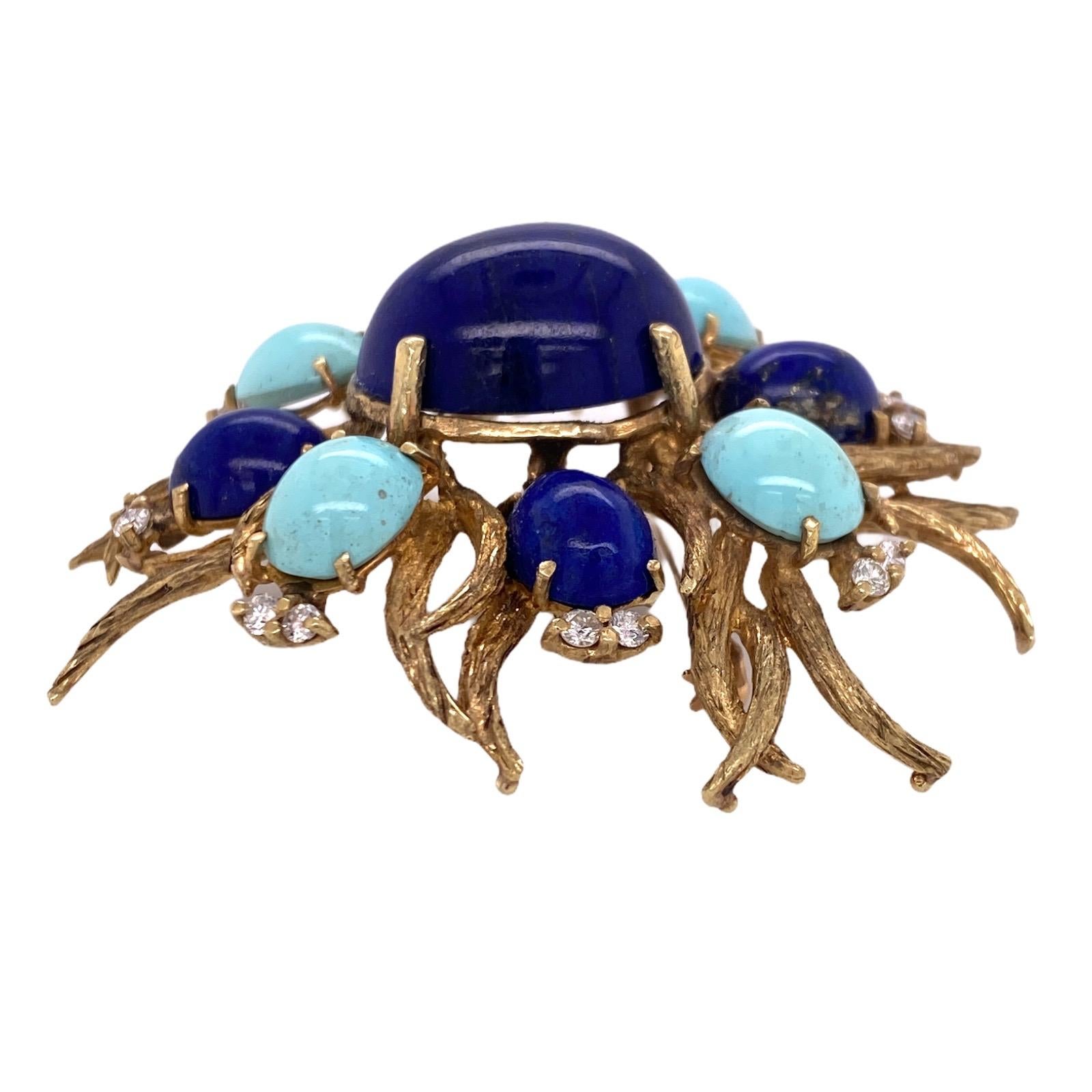Diamond, turquoise, and lapis lazuli vintage brooch fashioned in 14 karat yellow gold. The colorful brooch features a center approximately 19 carat lapis lazuli gemstone with surrounding turquoise, lapis, and diamonds. The 16 round brilliant cut