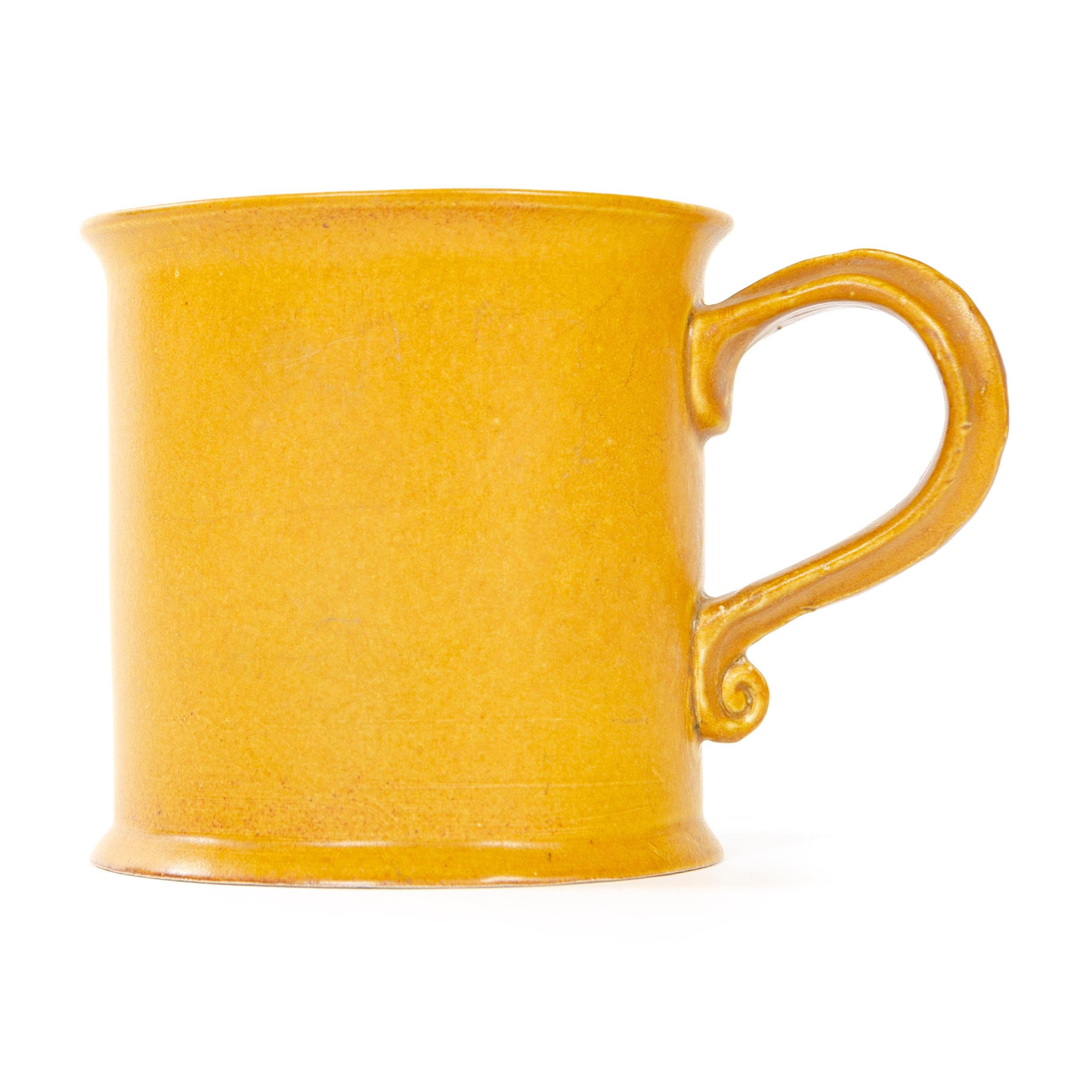 A substantial coffee or cocoa mug with golden matte glaze.