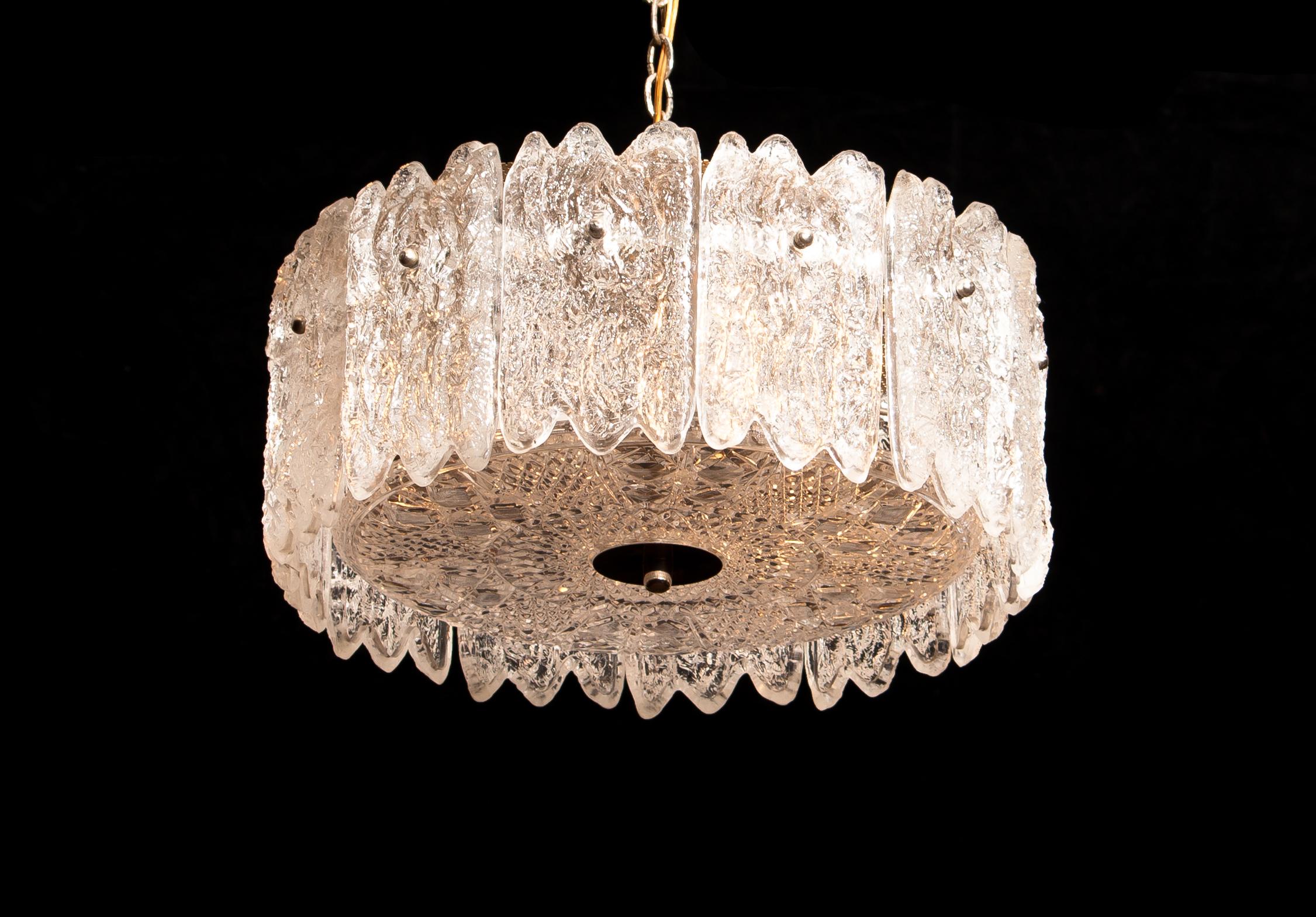 Very beautiful hanging lamp designed by Carl Fagerlund for Orrefors Sweden.
This lamp is build-up with lovely 'ice-sculptures' crystal elements.
The total height of the lamp is 105 cm but is adjustable to a shorter height.
It is in wonderful