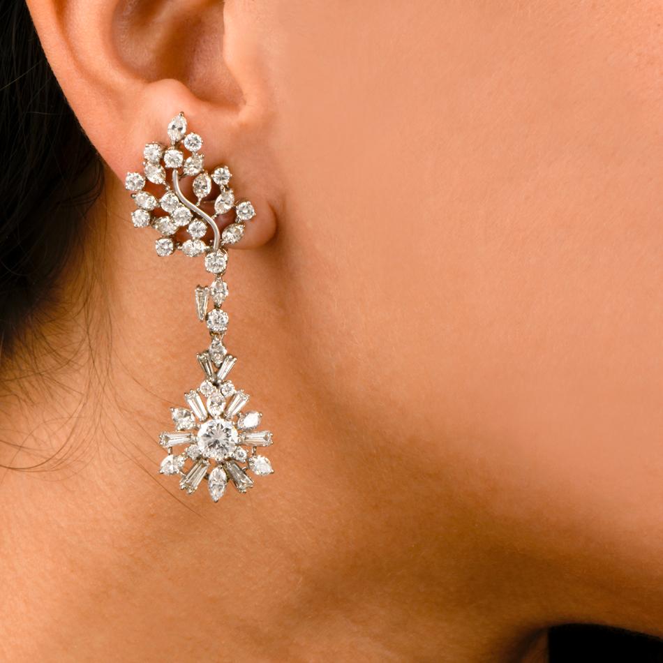 These elegant 1960's chandelier drop earrings are crafted in solid platinum. Exposing a pair of diamond-swathed cluster profiles as ear clips. These exquisite earrings are adorned with 2 genuine   high quality round cut diamonds approx. 1.52 carats