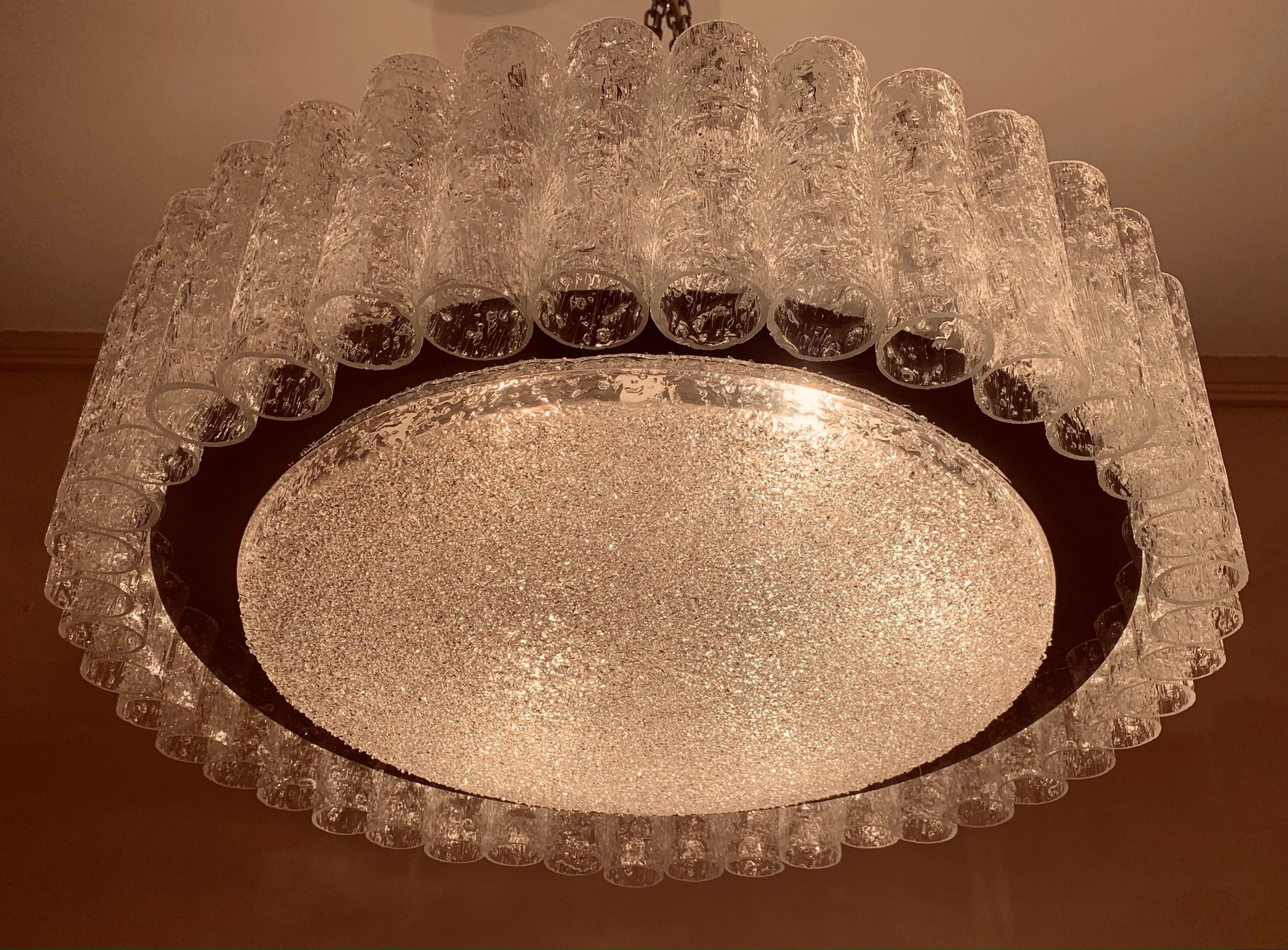 Midcentury, circular, hanging pendant ceiling light, manufactured by Doria Leuchten in Germany during the 1960s. The light features 41 textured, crystal glass tubes, suspended from a chrome and white metal frame, which surround a crystal glass disc