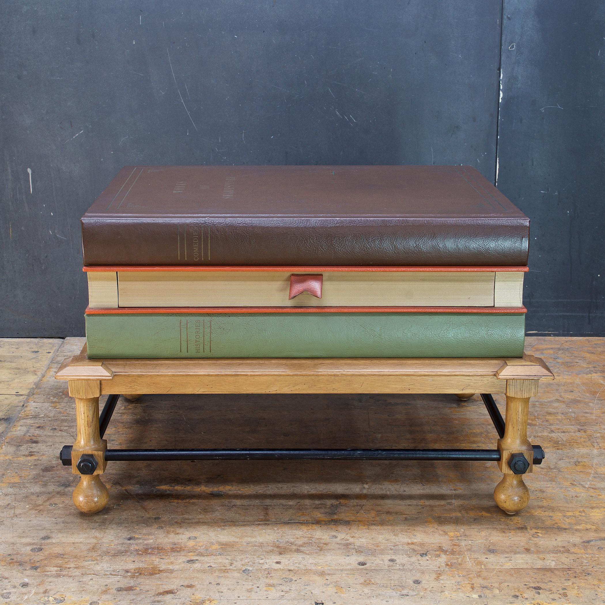 A rare John Dickinson designed Faux-Book Coffee Table for Drexel, part of the short lived Et Cetera series. Three large stacked Shakespeare books make up the tabletop, with the middle book having a pull-out single drawer, the pull resembling a