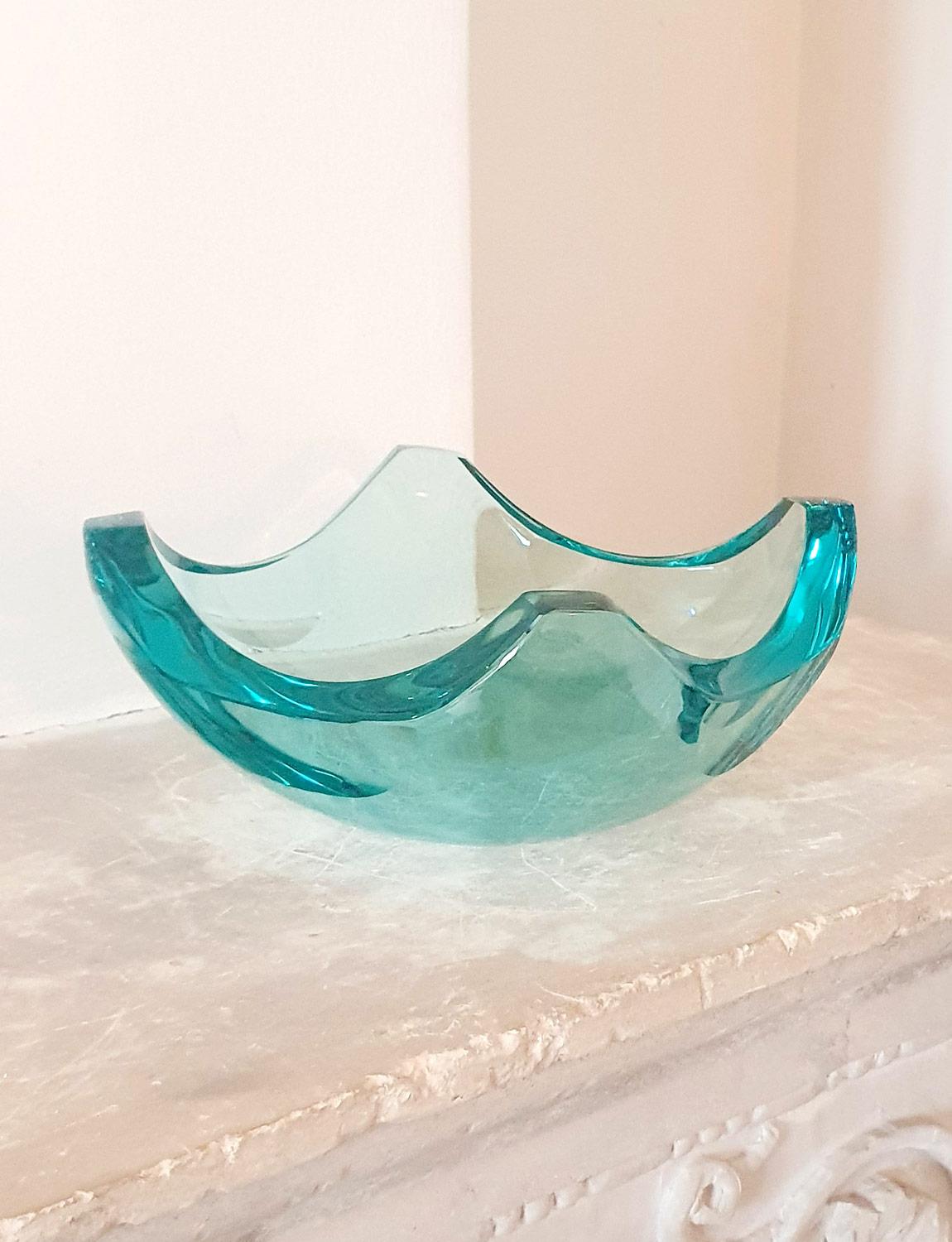 A very beautiful example of a large Fontana Arte centerpiece. This wonderful Milanese heavy glass bowl is a vibrant turquoise colour. It has four folded corners making what was once a large square piece of glass into a beautiful curved bowl. Perfect
