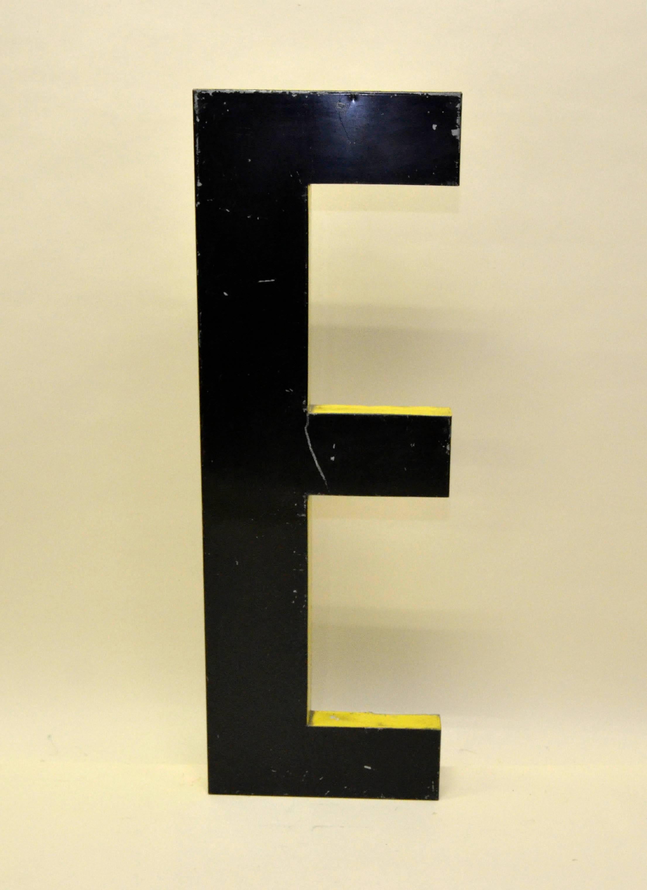 1960s large French black metal capital letter E with bright yellow profile. 

 