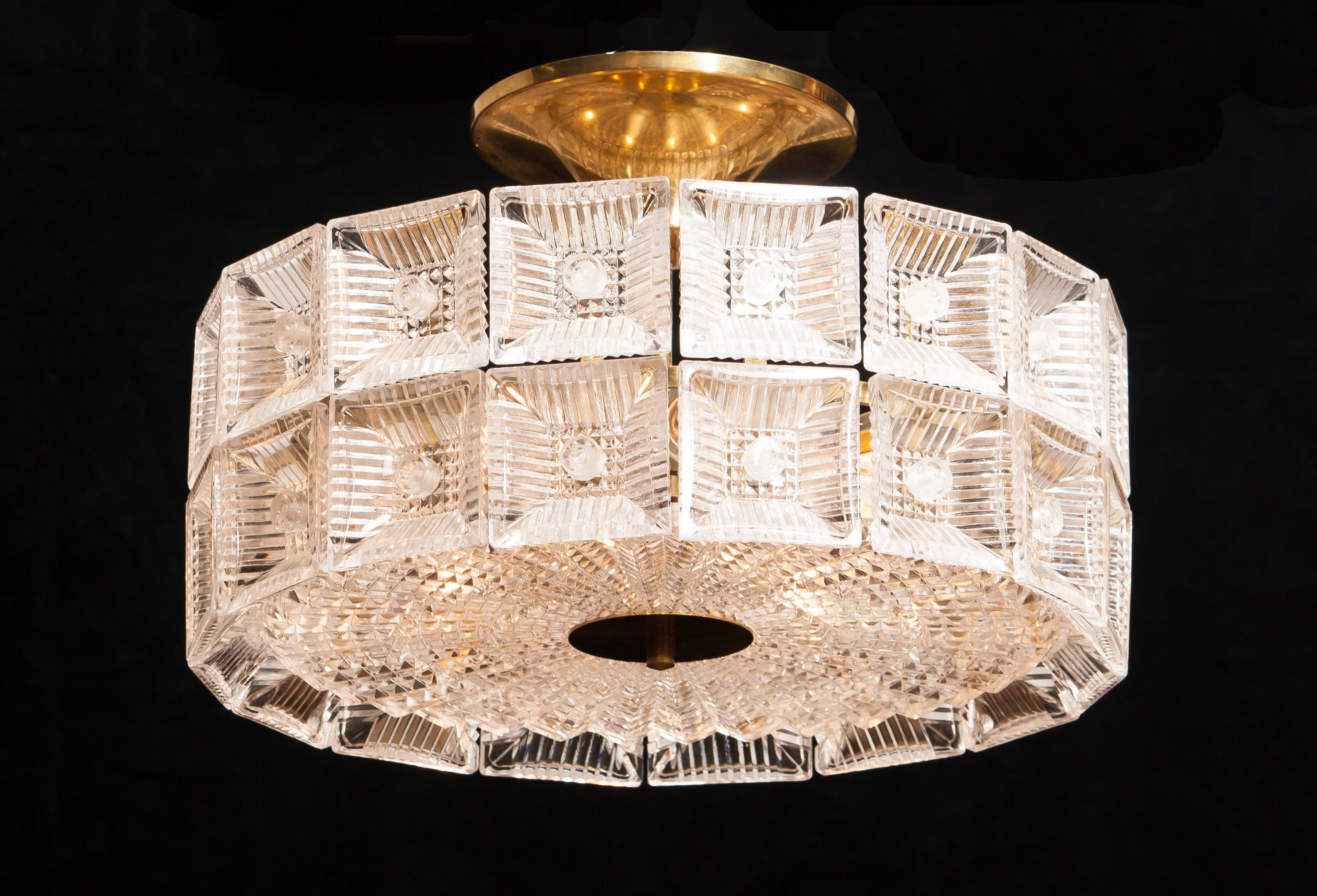 Magnificent ceiling light designed by Carl Fagerlund for Orrefors Sweden.
This lamp is made of beautiful brass and glass elements.
It is in a wonderful condition.
Period 1960s.
Dimensions: H 25 cm, ø 42 cm.