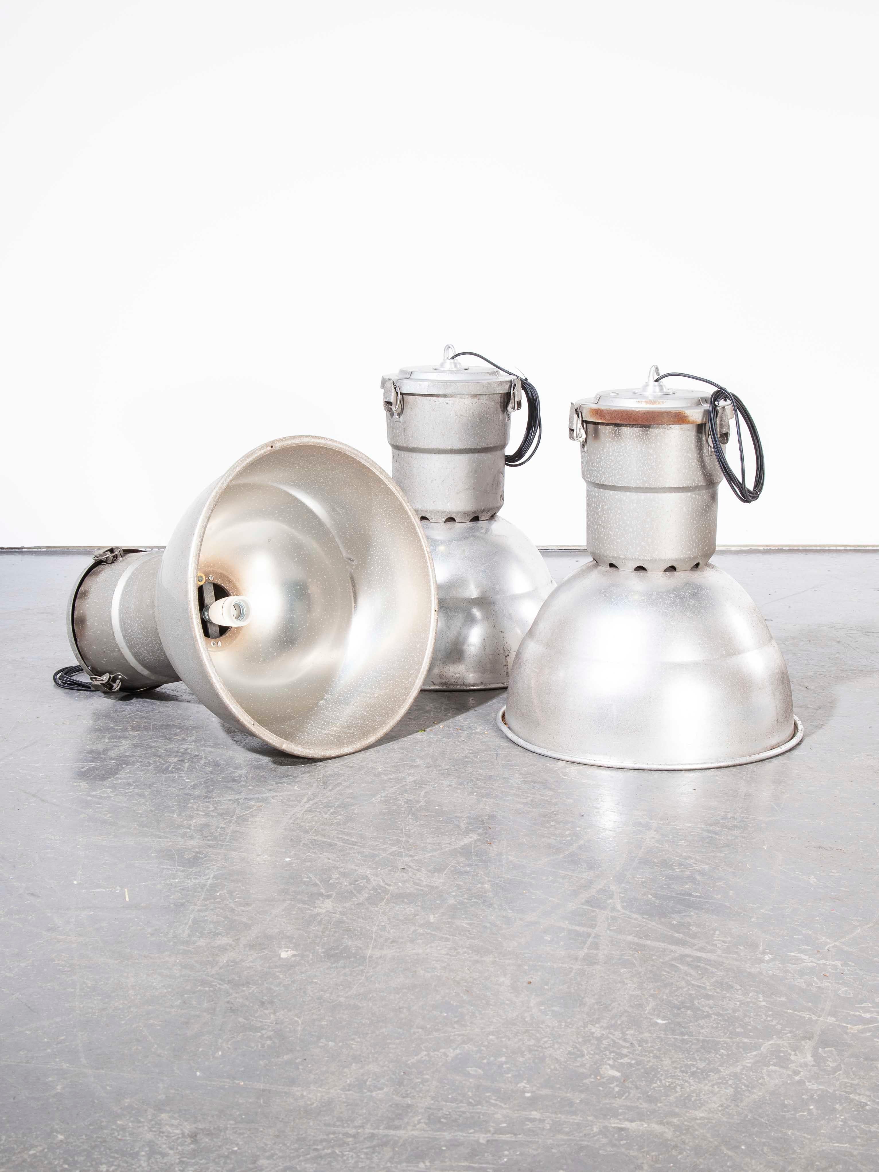 1960s large industrial spun aluminium French ceiling pendant lamps/light shades. Featuring large spun aluminium shades and aluminium galleries tops. The key feature of these lamps is their aluminium construction and original condition and size, we