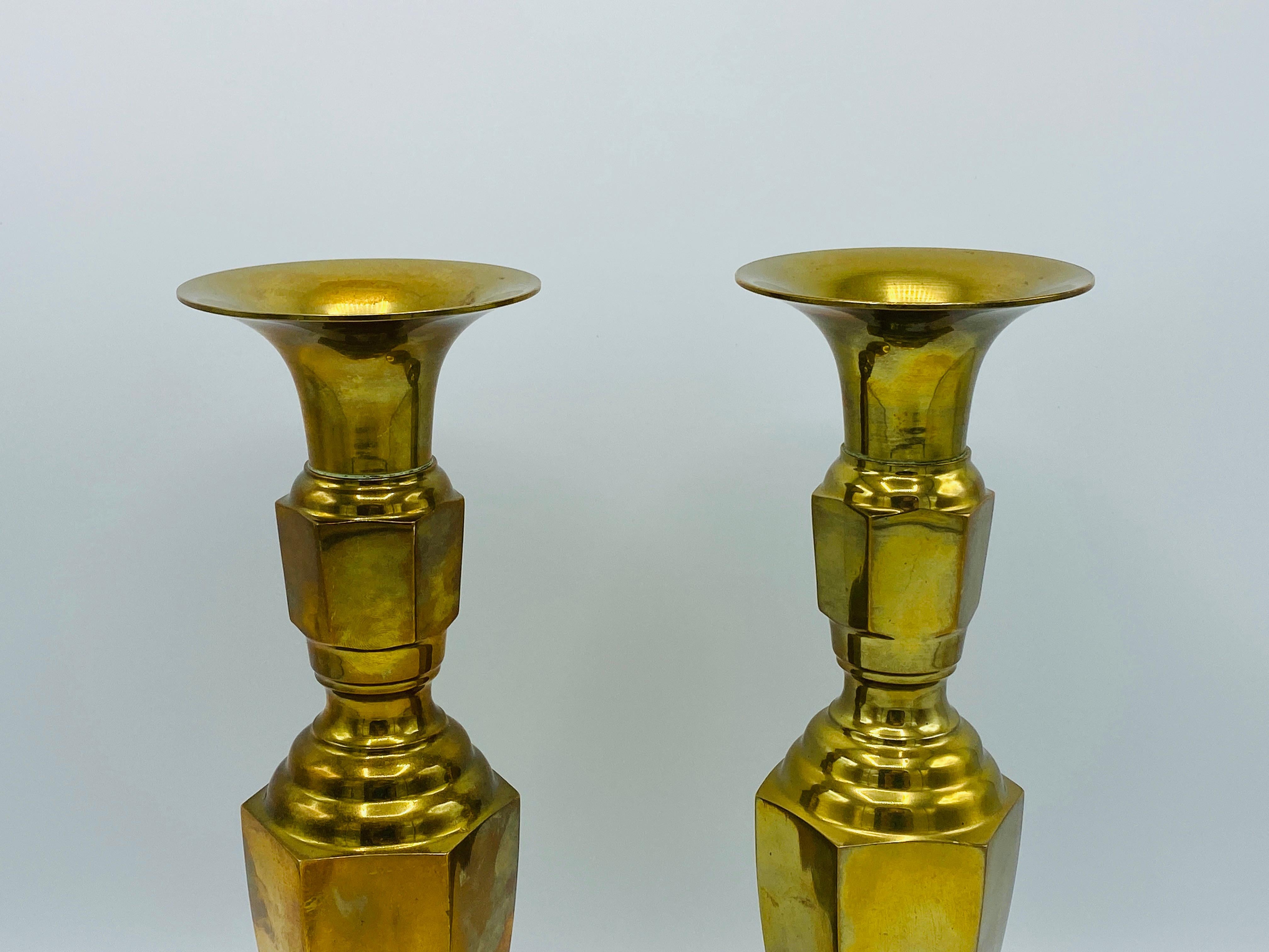 Listed is a fabulous, pair of 1960s Italian brass candlesticks. The pair stand 11.88