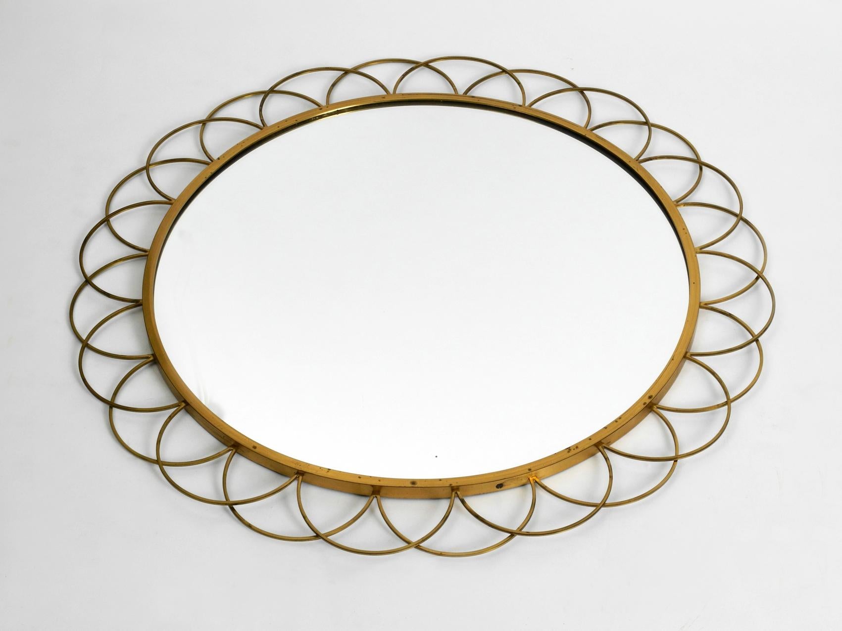 Beautiful rare large Italian brass wall mirror from the early 1960s. Frame and the rings are made of heavy brass. Abstract minimalistic design.
Mirror without damages. No scratches or chipping. Not dusty. Frame with slight patina. No damages to the