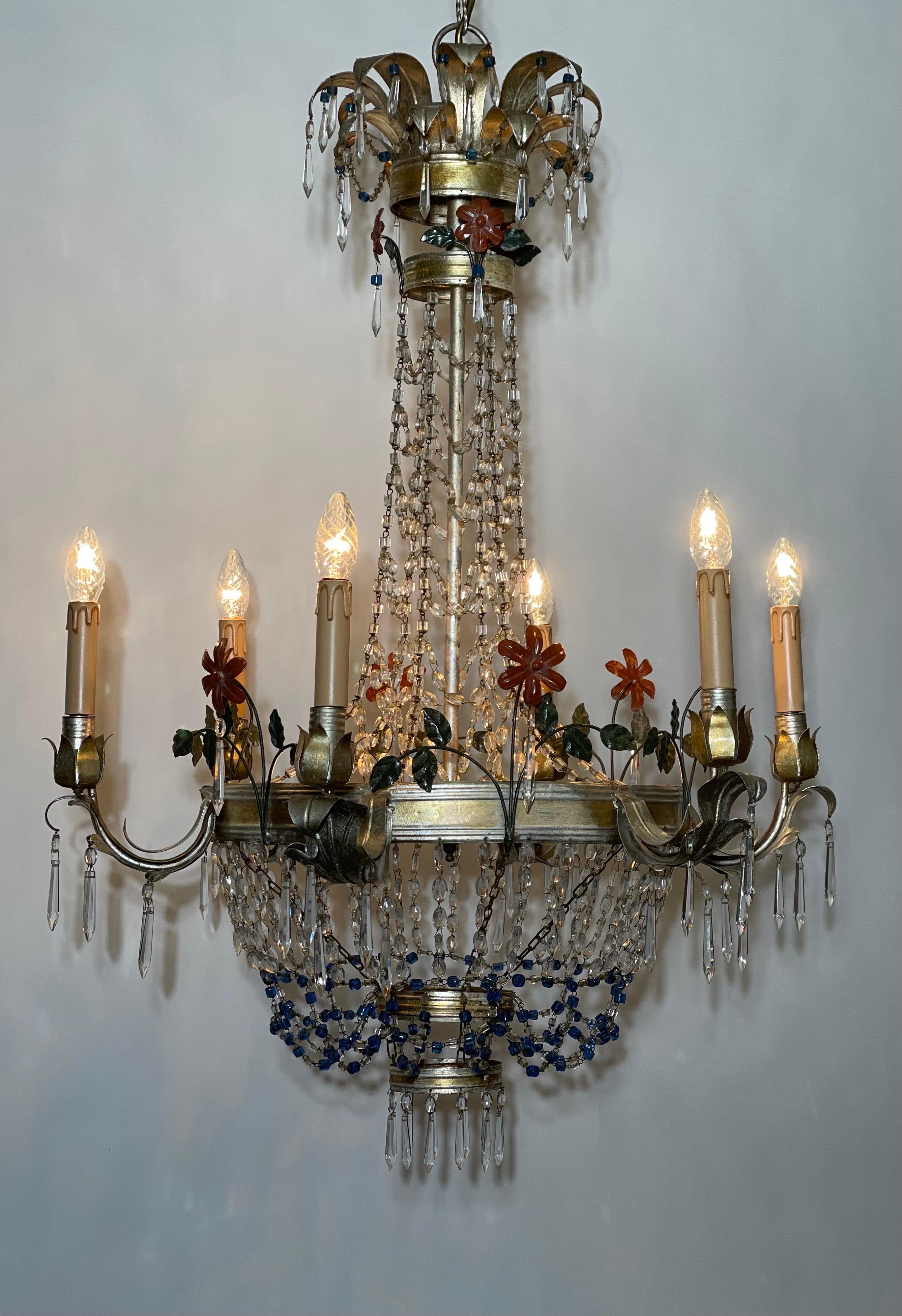 A beautiful, large Regency style Italian silvered iron and crystal chandelier, circa 1960s.
Decorated with colorful flowers and blue crystal pendants.
Measurements: height of the fixture only 41.33 inches, totally height 80.70 inches (with chain