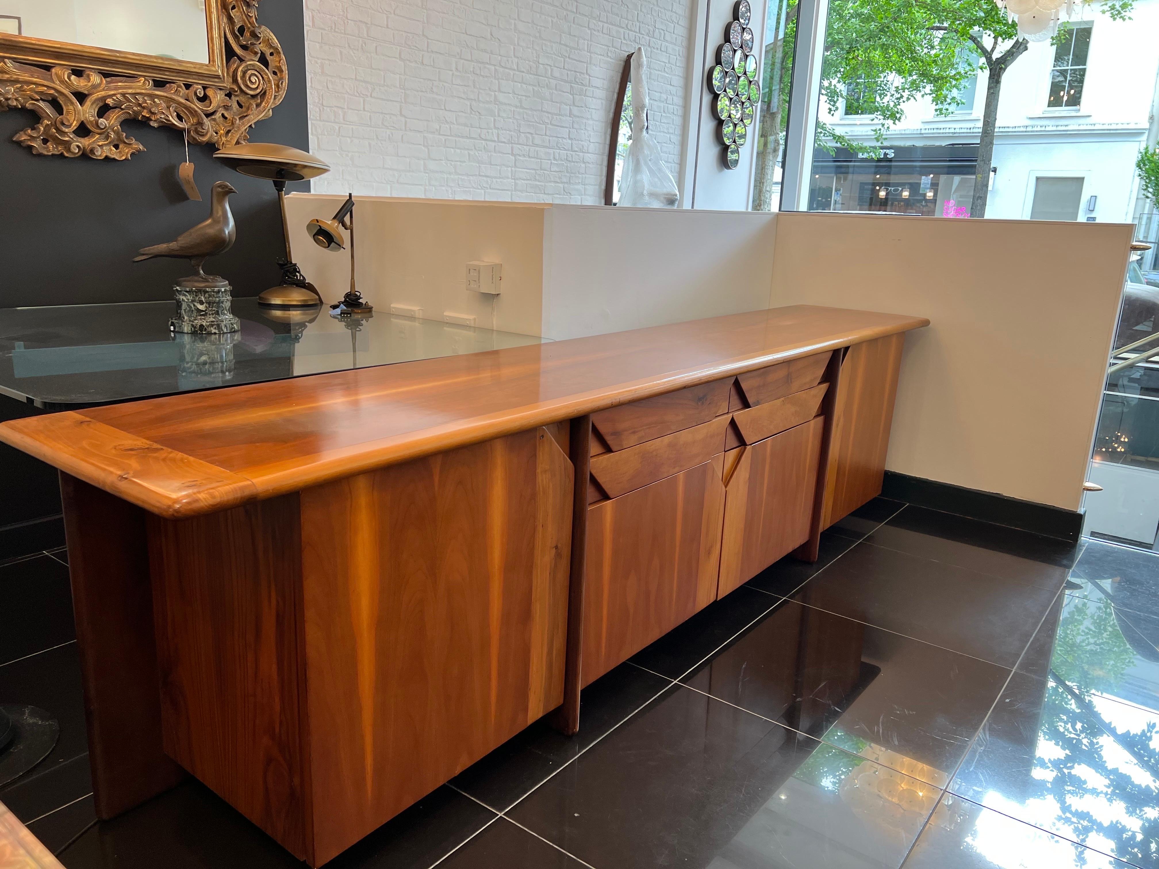 An extraordinary walnut credenza by Ammanati & Vitelli in a fabulous architectural design with four doors and four drawers. The cabinet can be dismantled in four sections with a single 2.85m top for ease of transport and shipping. 

Dimensions: