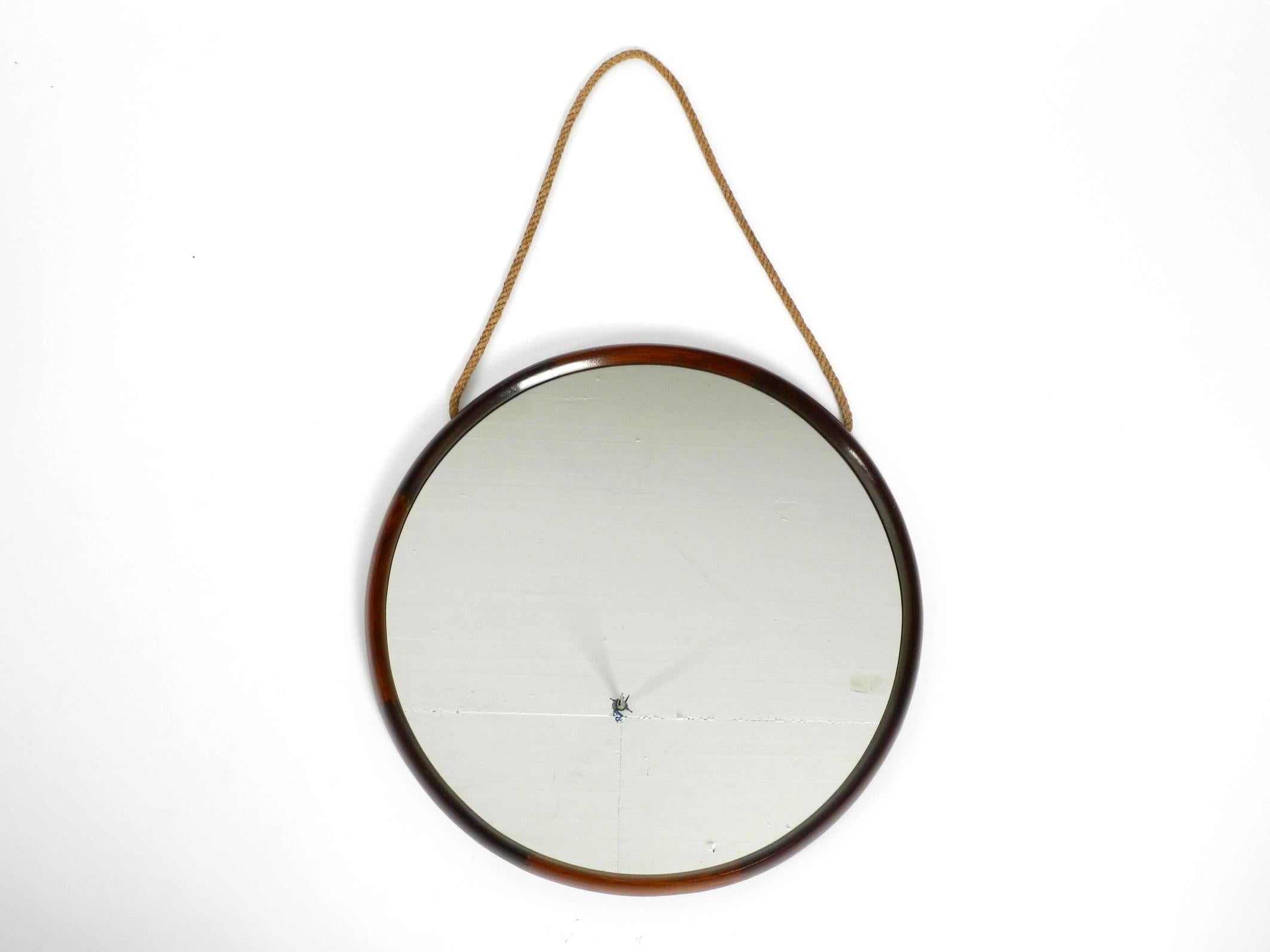 Round, original, large, beautiful wall mirror with a teak frame. Made in Italy.
The original thick knitted hanging rope is made of jute or sisal, it is undamaged and sturdy.
Very high quality workmanship in a Minimalist Italian design.
100%