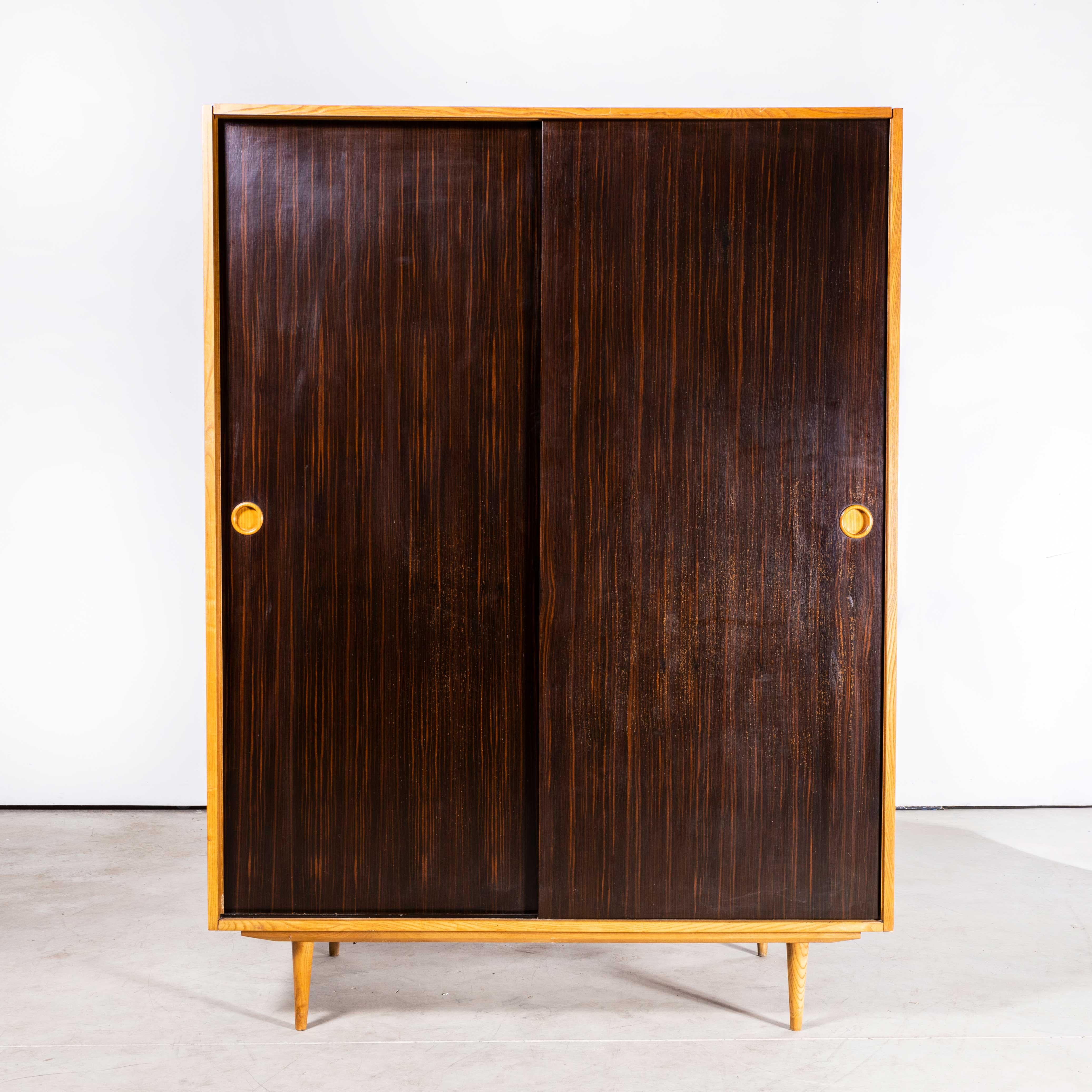 1960s Large midcentury Dark Oak Wardrobe
1960s Large midcentury Dark Oak Wardrobe. Beautiful simple and Classic midcentury wardrobe sourced in the Czech Republic. The wardrobe is beautifully made with rich dark stained striped oak doors with a