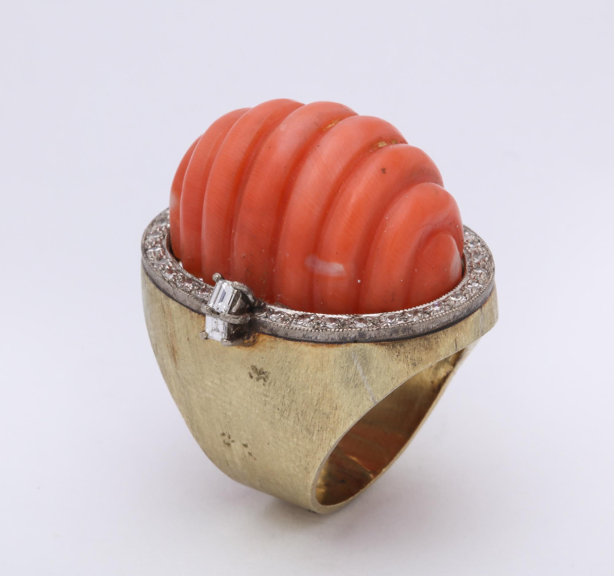 One Ladies Large 14kt Gold Fluted Coral Ring Embellished With Numerous Diamonds Around Edge Of Large Carved Coral. Ring Is Furher Flanked By Two Emerald Cut Diamonds. Current Ring Size 6 And May Easily Be Resized To Any Size Required. Created In The