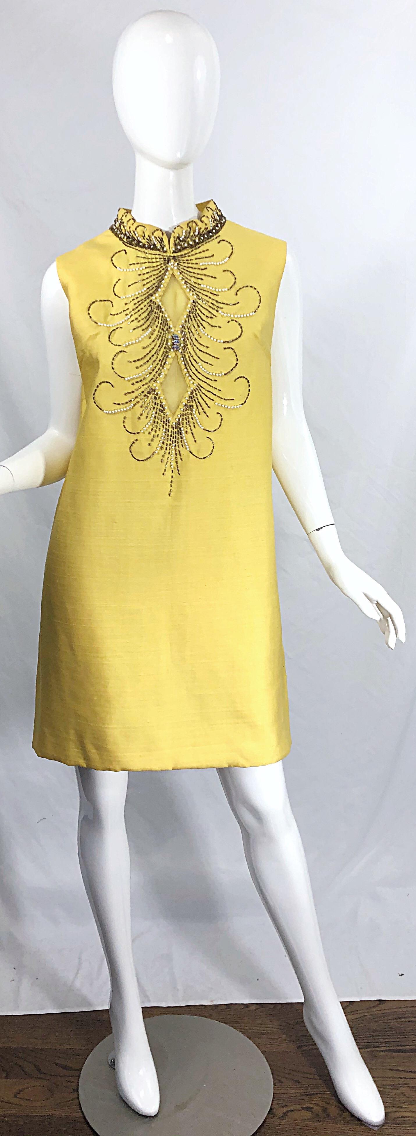 Chic early 60s larger sized yellow beaded, rhinestone and sequin silk shantung shift dress ! Features hundreds of hand sewn beads throughout. Semi sheer diamond shaped mesh cut-outs at the bust. Hidden metal zipper up the back with hook-and-eye
