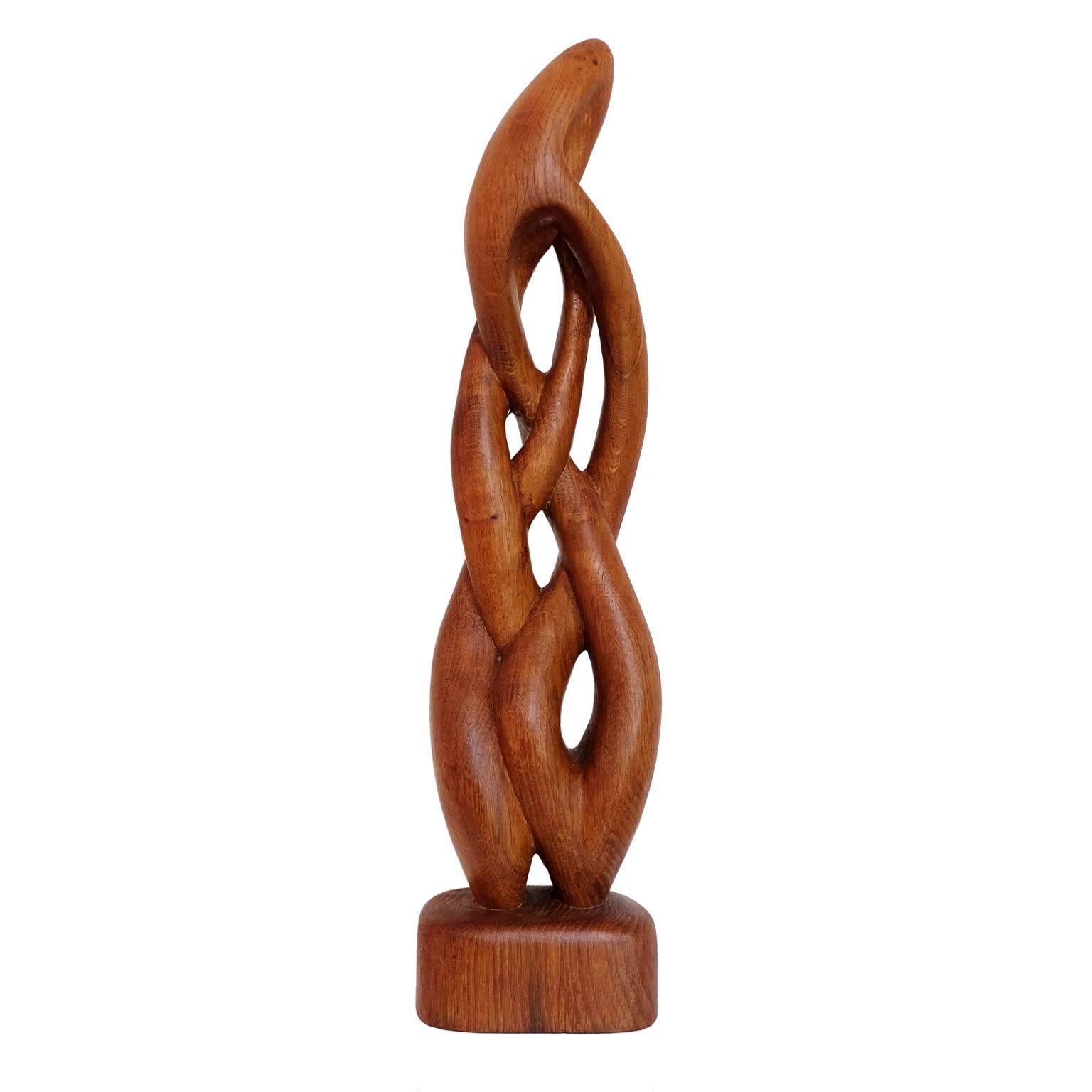 1960s abstract wooden sculpture designed and made in the UK.

Hand carved figured teak twisted form. 

Measures: H 58 cm x W 14 cm x D 12 cm.