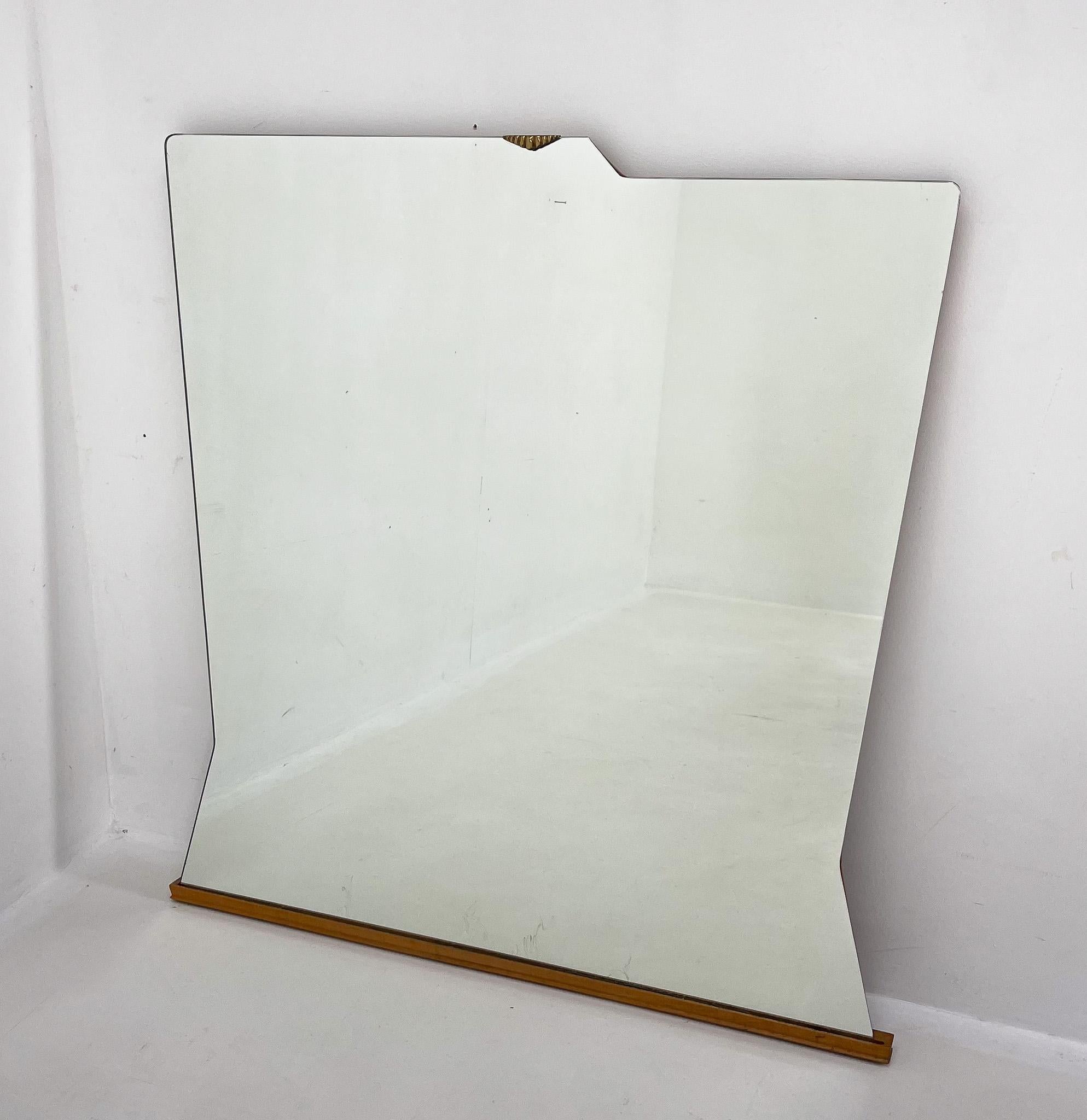 Large, asymetrical wall mirror mounted on wood with brass detail by Santambrogio & de Berti. Produced in Italy.