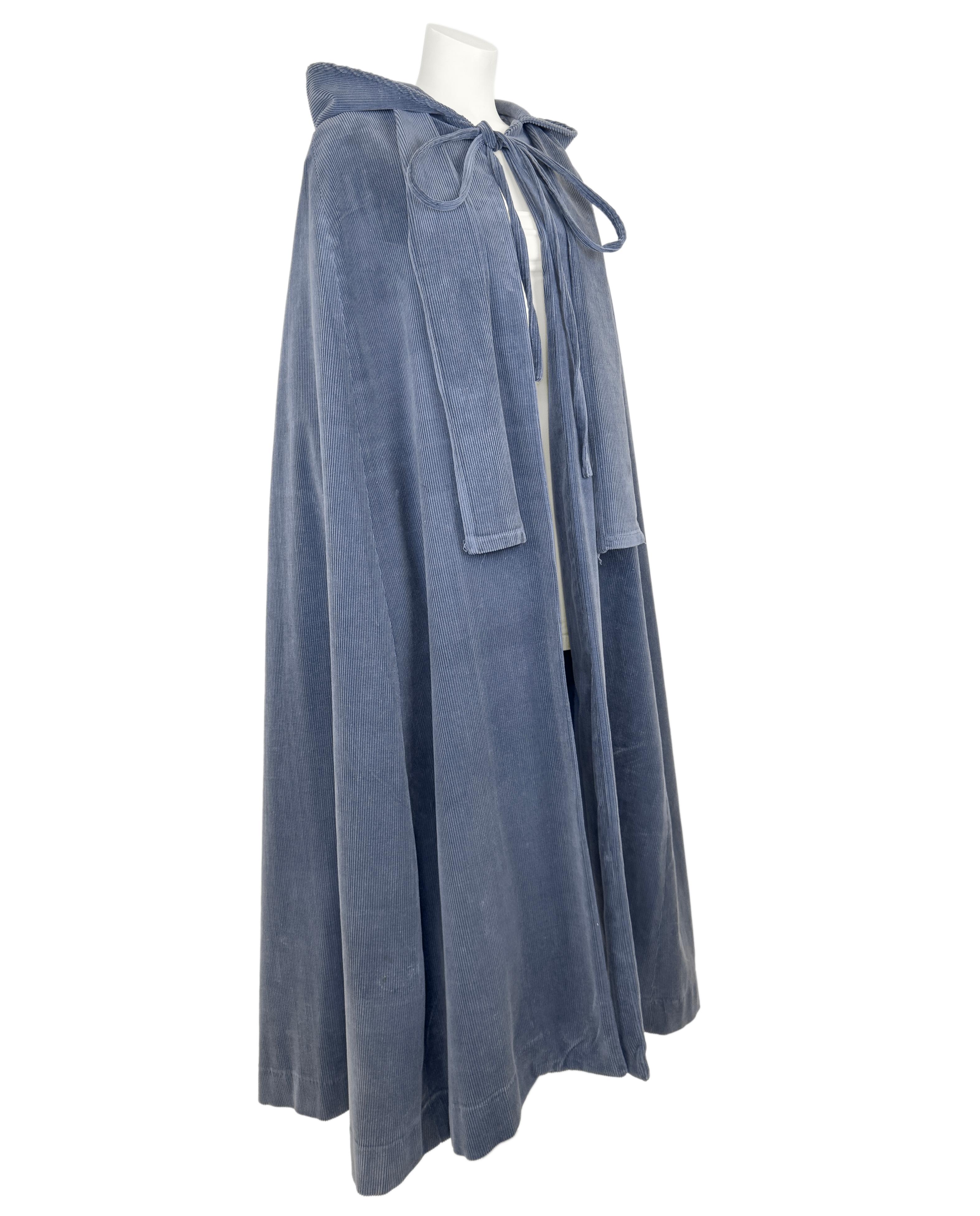 1960s Laura Ashley grey corduroy long cape with hood and drawstring tie at neck. In beautiful condition, this cape is a perfect topper for fall. An early piece of the Laura Ashley label, predating the bramble label and dating from their production