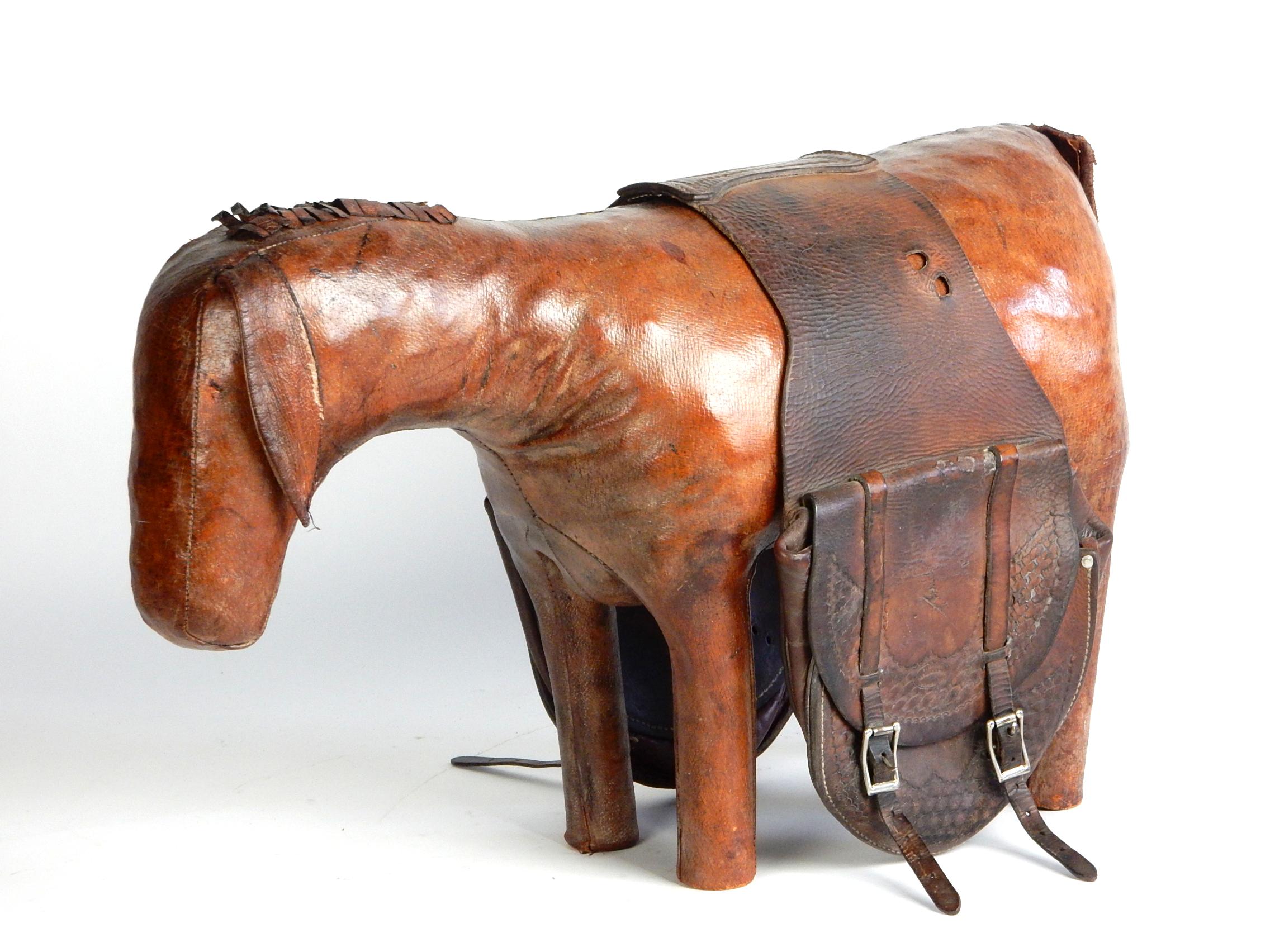 Whimsical handstitched leather burro ottoman by Dimitri Omersa.
As found with small vintage saddlebags added making him a functional piece of art
to store stuff in (bags not attached).
All parts such as tail, ears and mane are in place. Eyes are