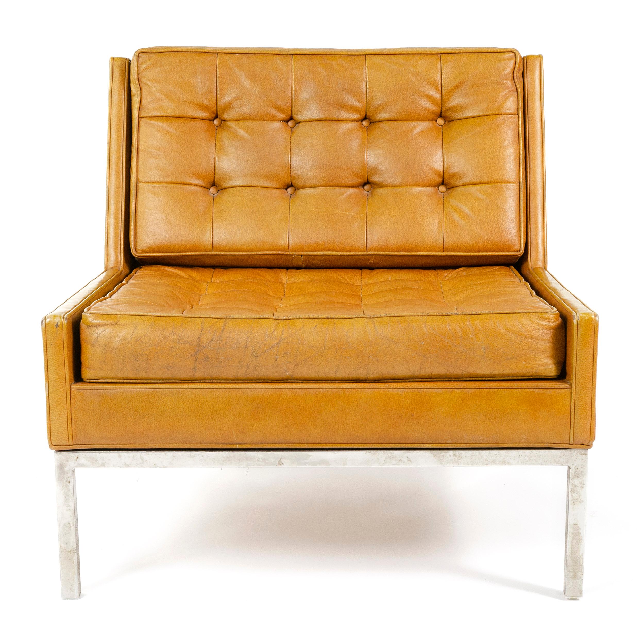 Dunbar leather lounge chair its frame having slightly raised sides as well a slight 'wing' effect to the back together forming channels which the button tufted seat and back cushions fit in to allowing the cushions to sit flush with the sides and