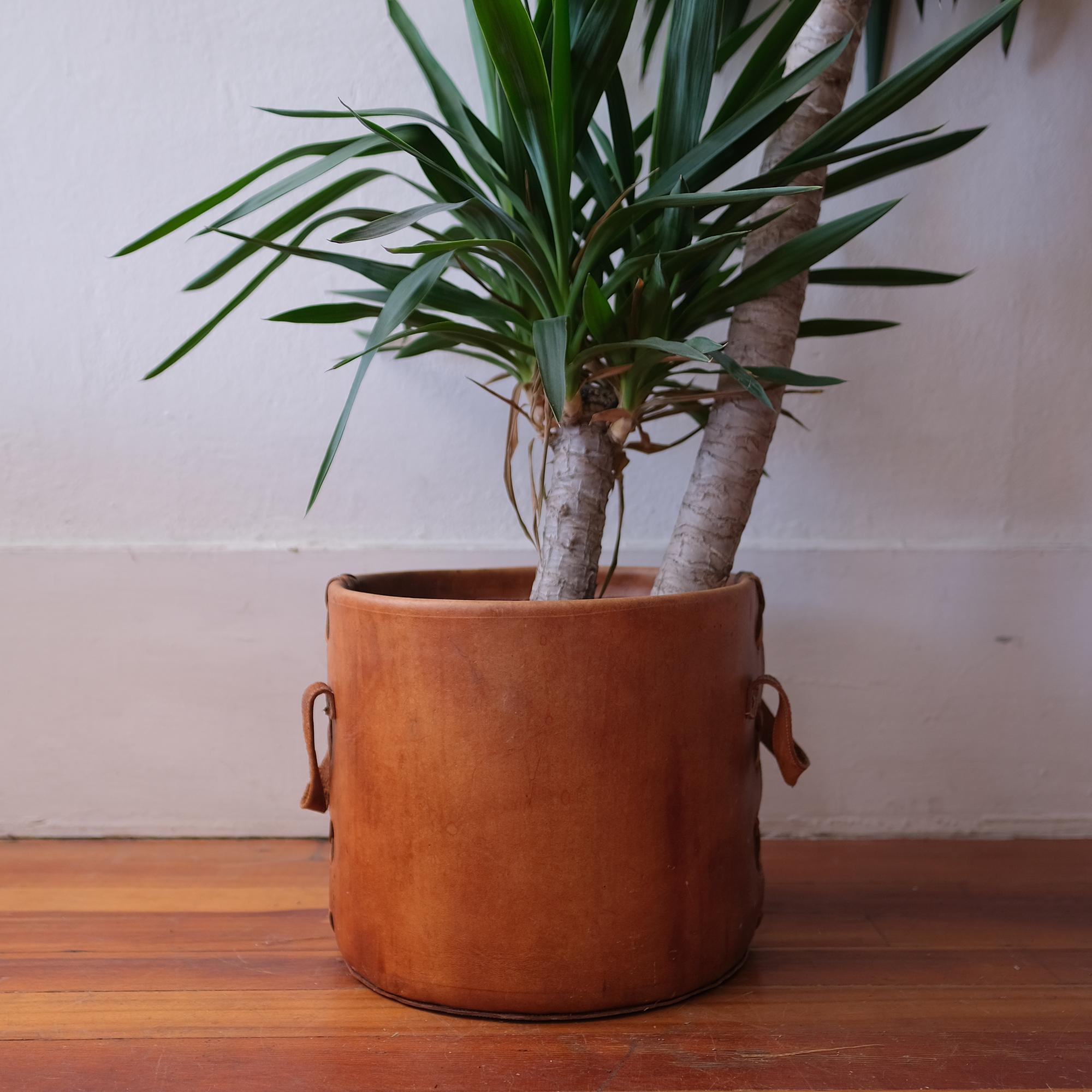 1960s handcrafted leather planter pot cover or trash can. Thick leather with great stitching over a fiberglass liner.