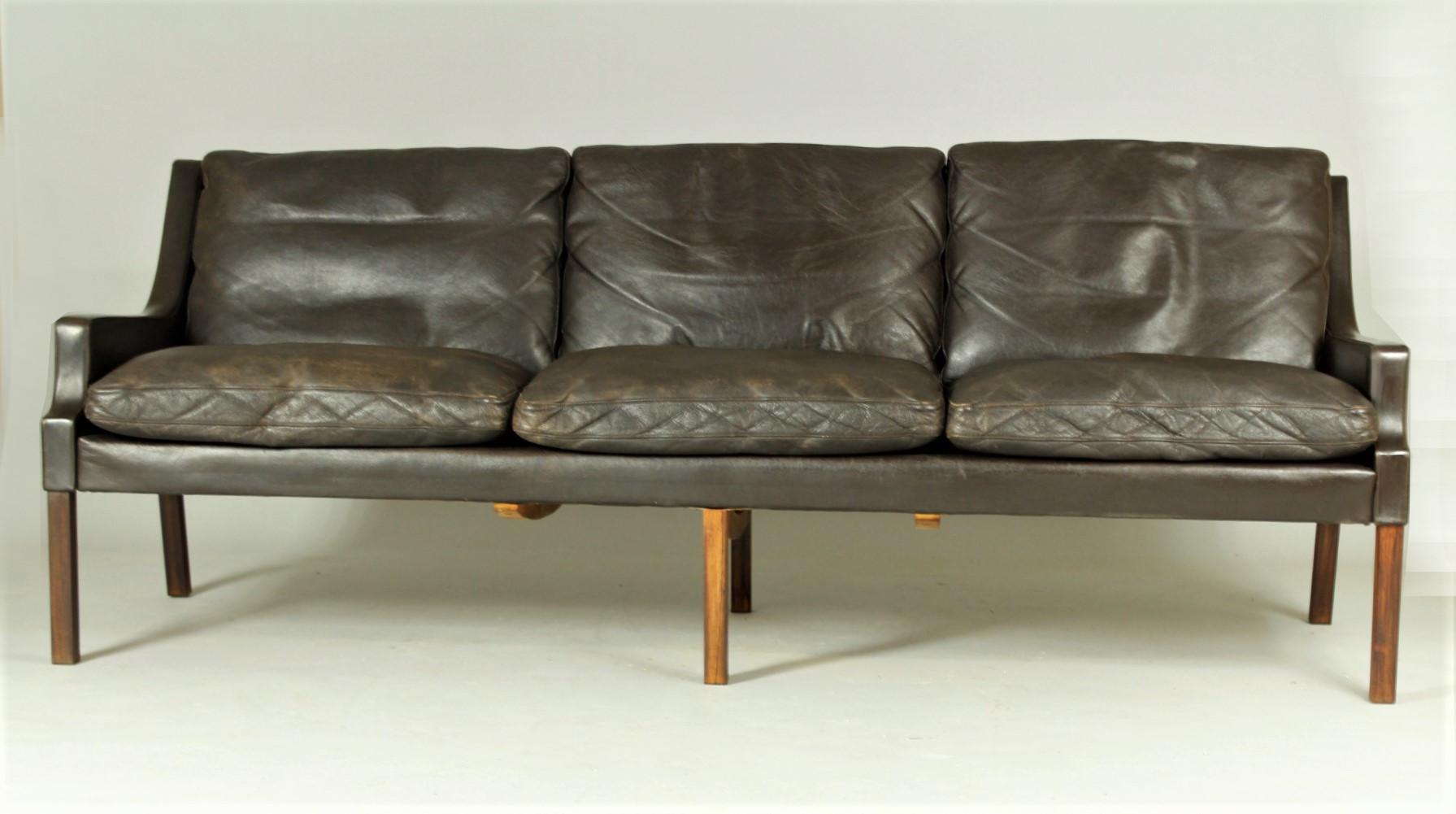 This Danish sofa from the 1960s was designed by Rud Thygesen and manufactured by AS Vejen Polstermøbelfabrik. It is in chocolate brown worn leather and is in good vintage condition.