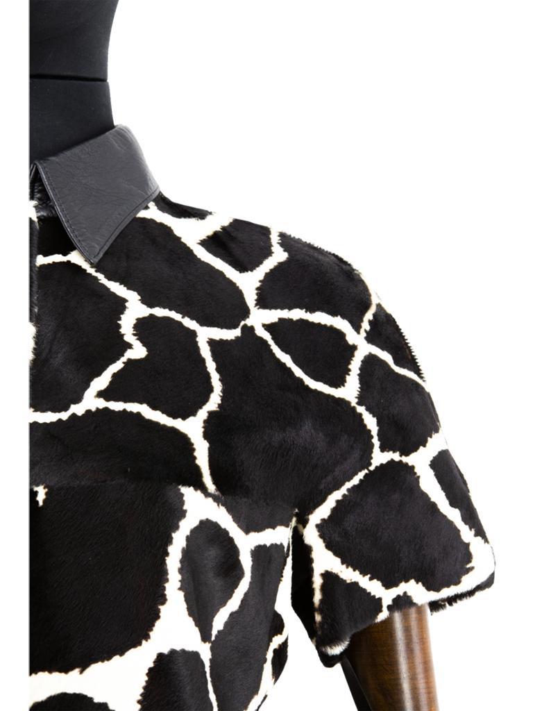 A late 1960’s Exclusive Ledermoden Regnier black and cream calfskin giraffe print shirt-jacket, featuring a black grained leather collar, deep front and back yoke with grown-on short sleeves, finished with a set of black stylised square concave