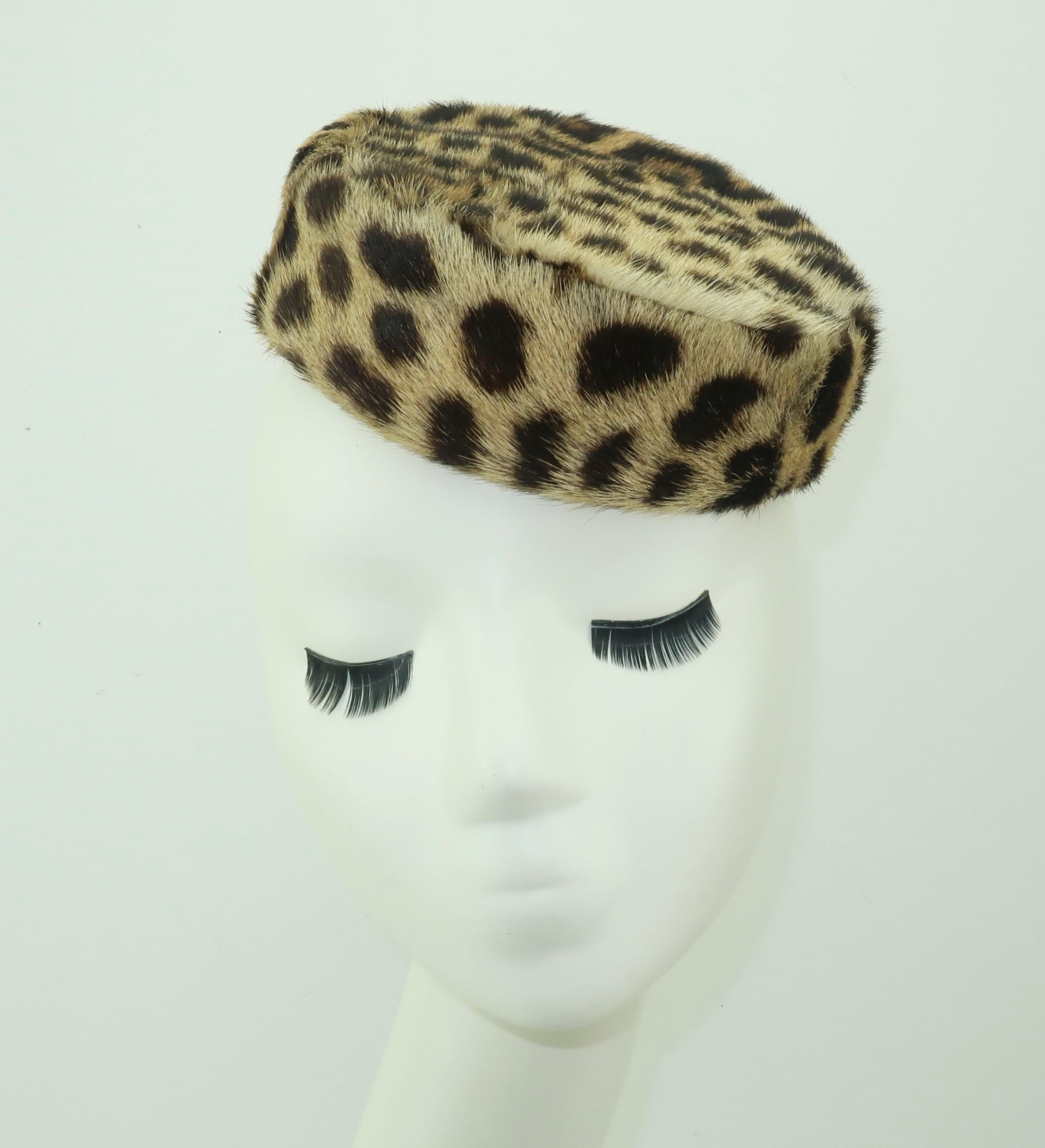 Add a bit of 1960's chic to your wardrobe with this leopard printed fur hat in an iconic pillbox silhouette.  Beautifully lined in black satin and outfitted with two combs for anchoring this purrrfect topper in the right spot.  Wear it like a tilt