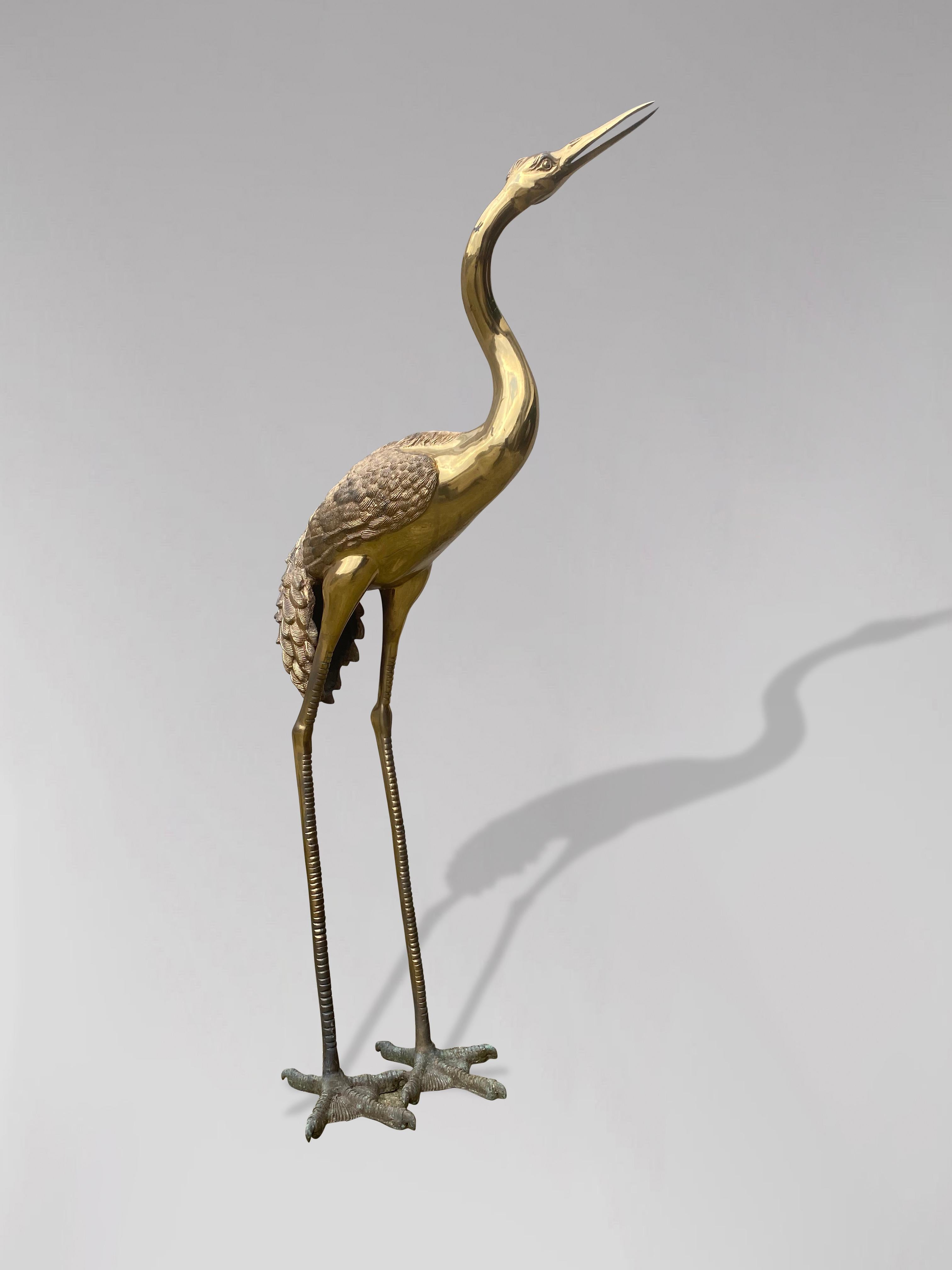 A 1960s life size free standing solid brass heron sculpture with an elegant posture with nice details and features. In perfect condition. A highly decorative piece which brings that Hollywood Regency glamour into your home.

The dimensions