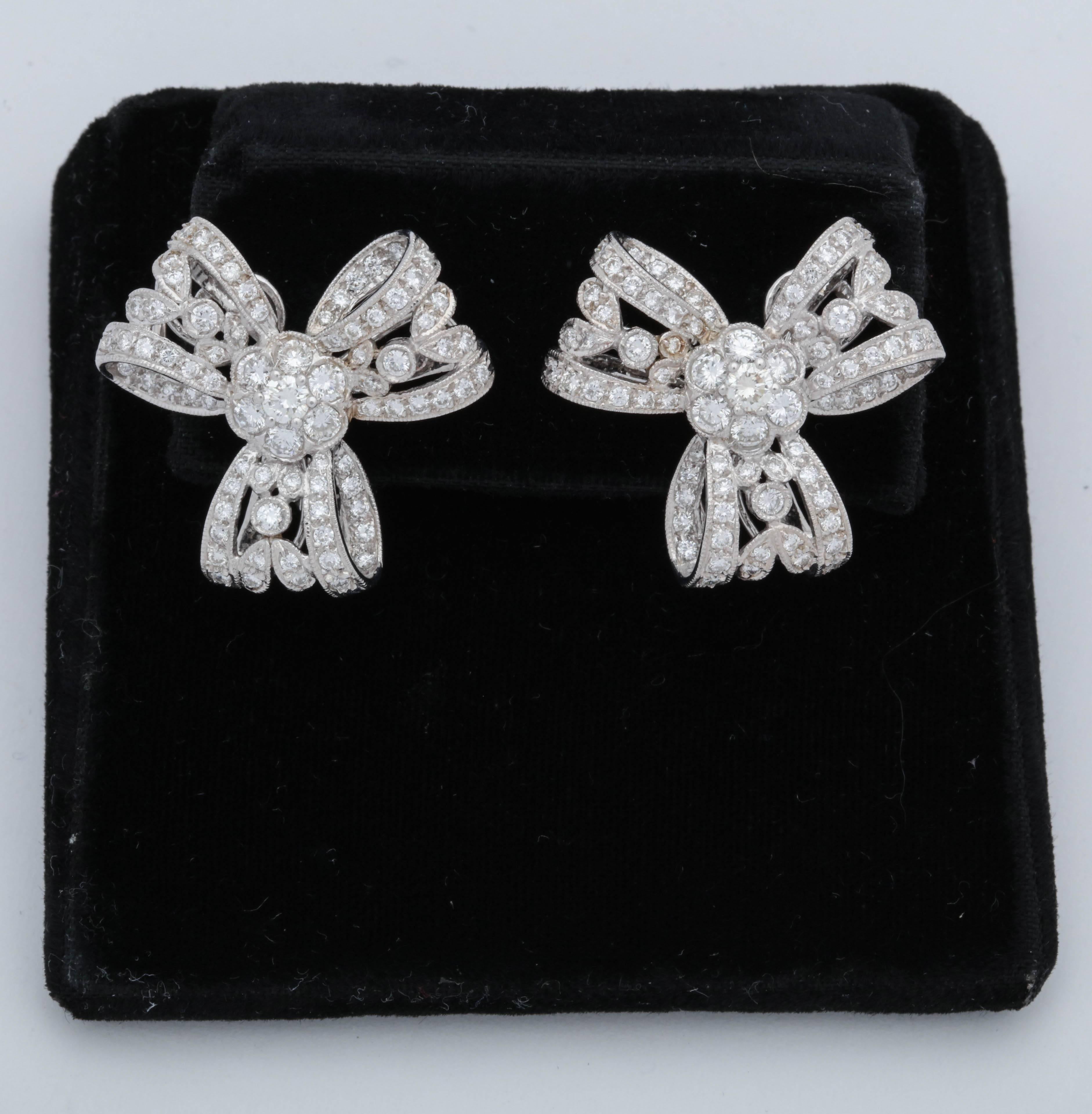 One Pair Of Ladies 18kt White Gold Clip On earrings,{NOTE Posts May Be Adde For Pierced Ears} Designed In a Light And Airy Figural Bow Knot Design Embellished With Numerous Very high quality full cut diamonds Weighing approximately 3.75 Carats Total