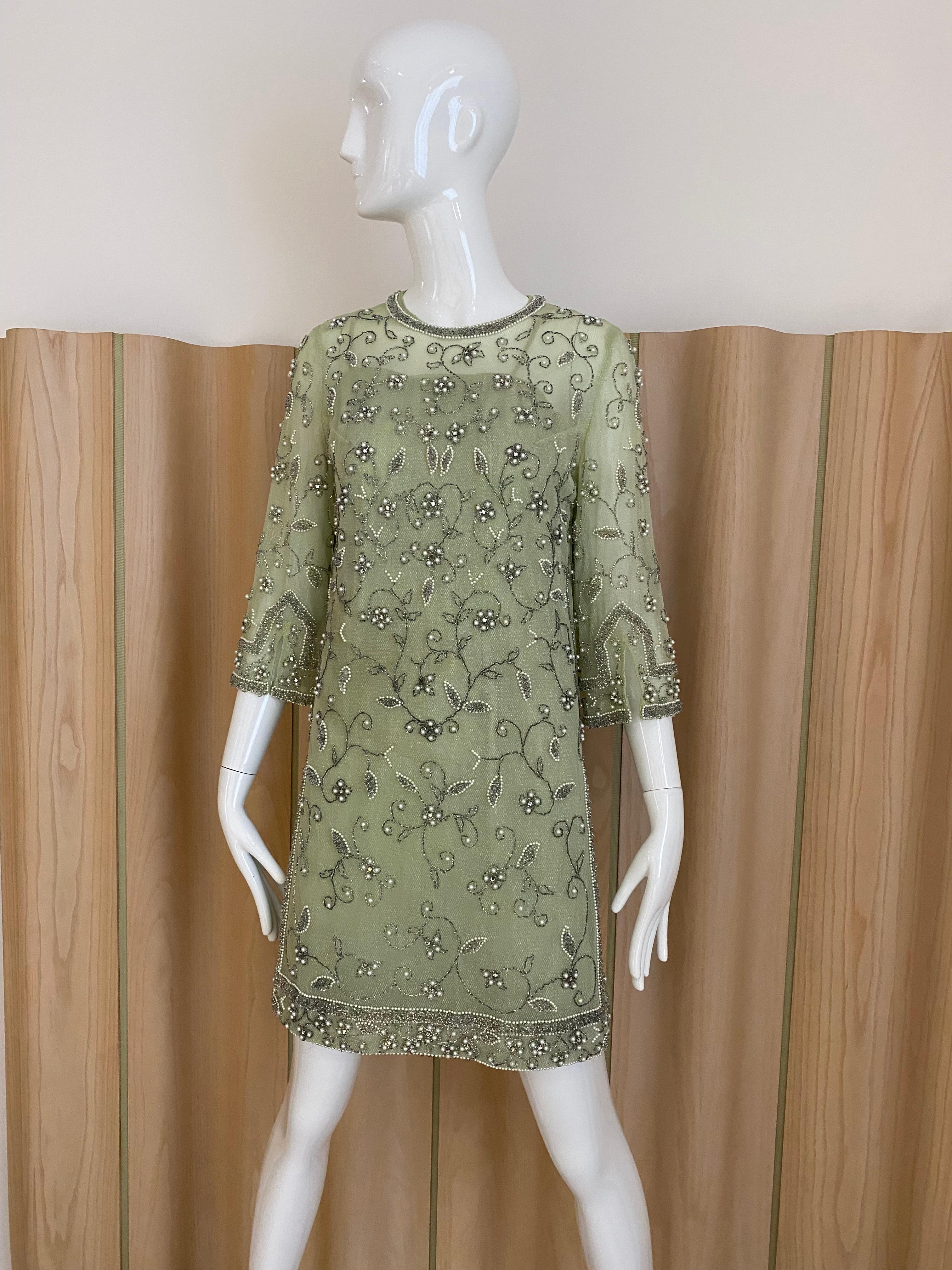 1960s Sheer light green sheer dress beaded in pearls   . Dress comes with light green slip. perfect for wedding or cocktail party 
Fit size 4

*** slip has stains see image attached