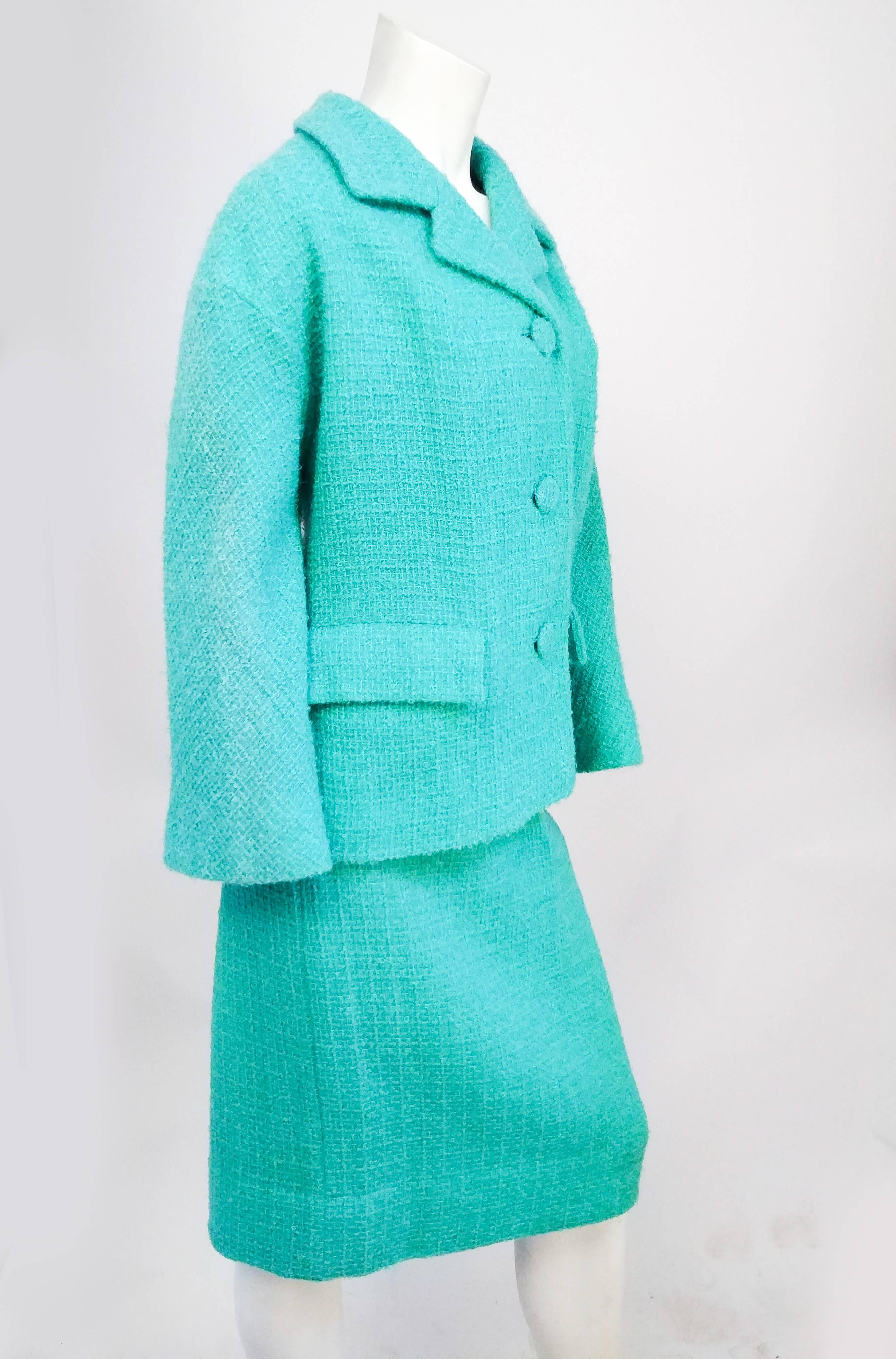 1960s Lilli Ann Aqua Wool Two Piece Skirt Suit. Wool bocle suit set with boxy 1960s silhouette notched lapel jacket, two front pockets, and matching covered button closure. 