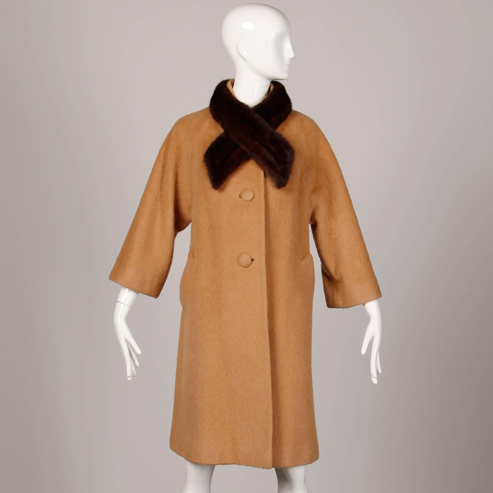 Vintage 1960s camel wool coat with genuine mink fur collar by Lilli Ann. Fully lined with front button closure. Hidden pockets. The marked size is 6, but the coat fits like a modern small-medium. The bust measures 42