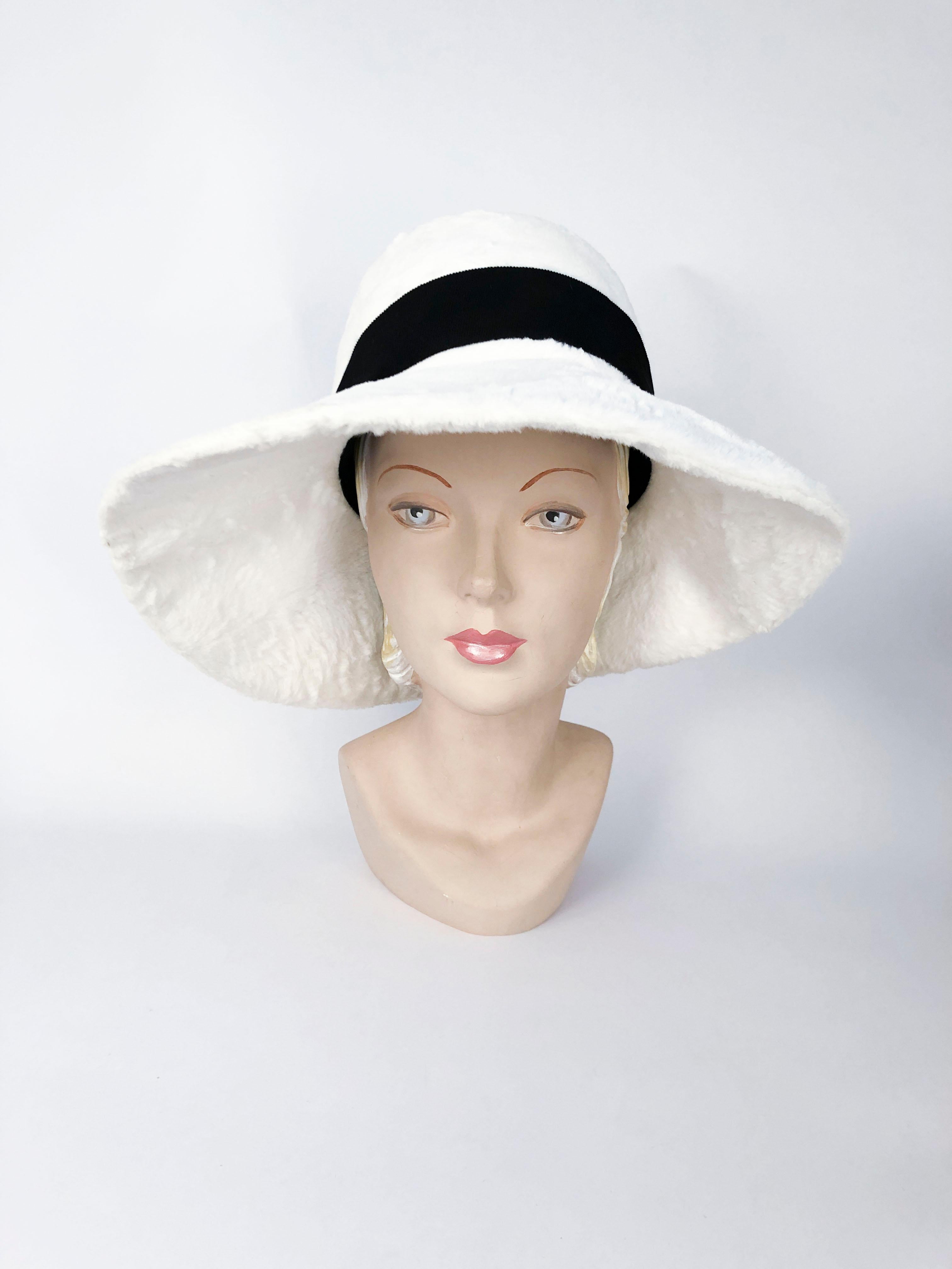 1960's Lilly Daché White Faux Fur Fashion Hat with high-crown and wide brim, decorated with a wide black grosgrain band and a covered buckle