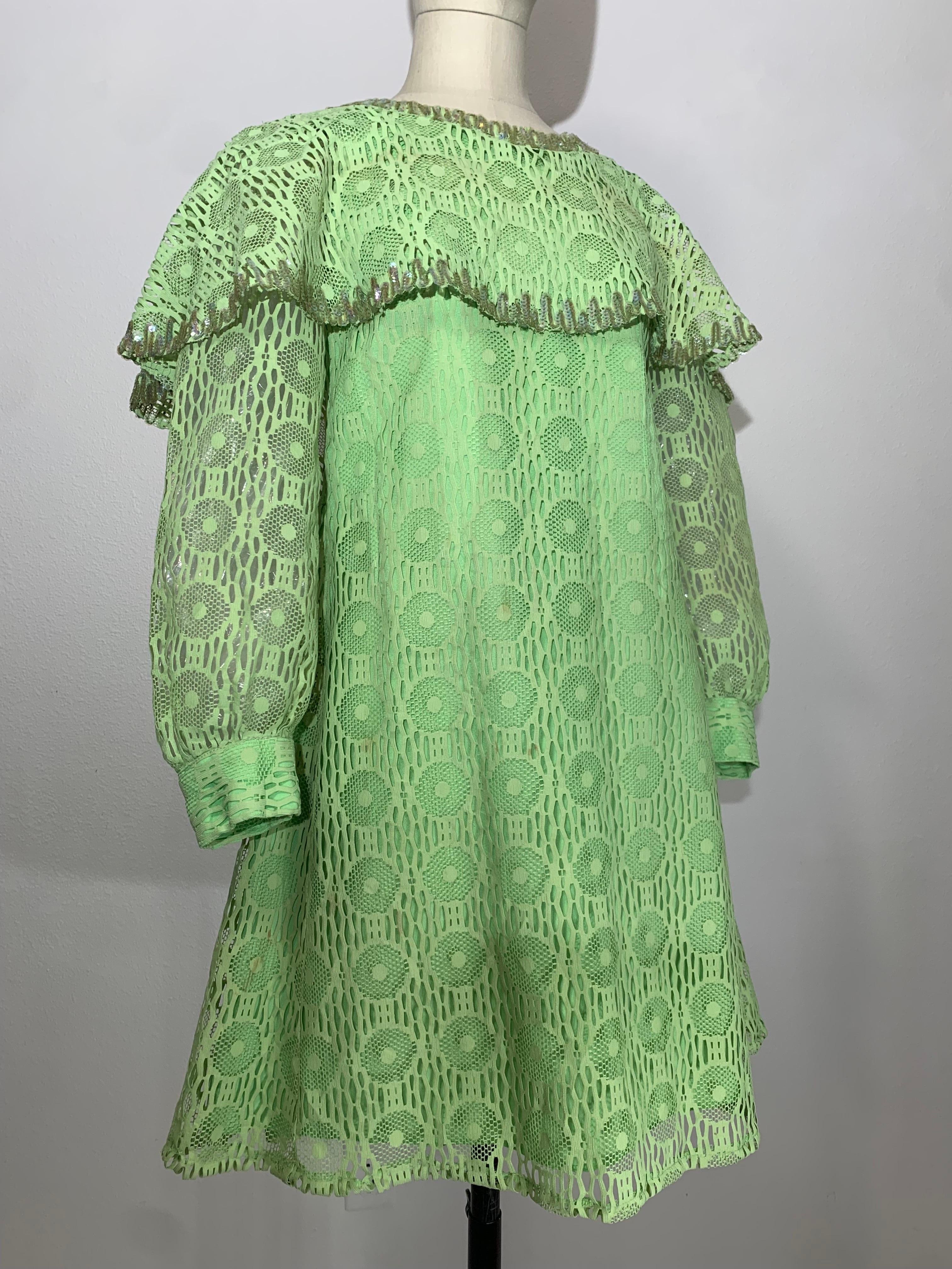 1960s Lime Green Net Lace Baby Doll Mod Mini Dress w Caplet & Banded Cuffs: A-line silhouette, fully lined with sheer sleeves and sequin trimmed caplet and cuffs. Fits up to US size 8.
