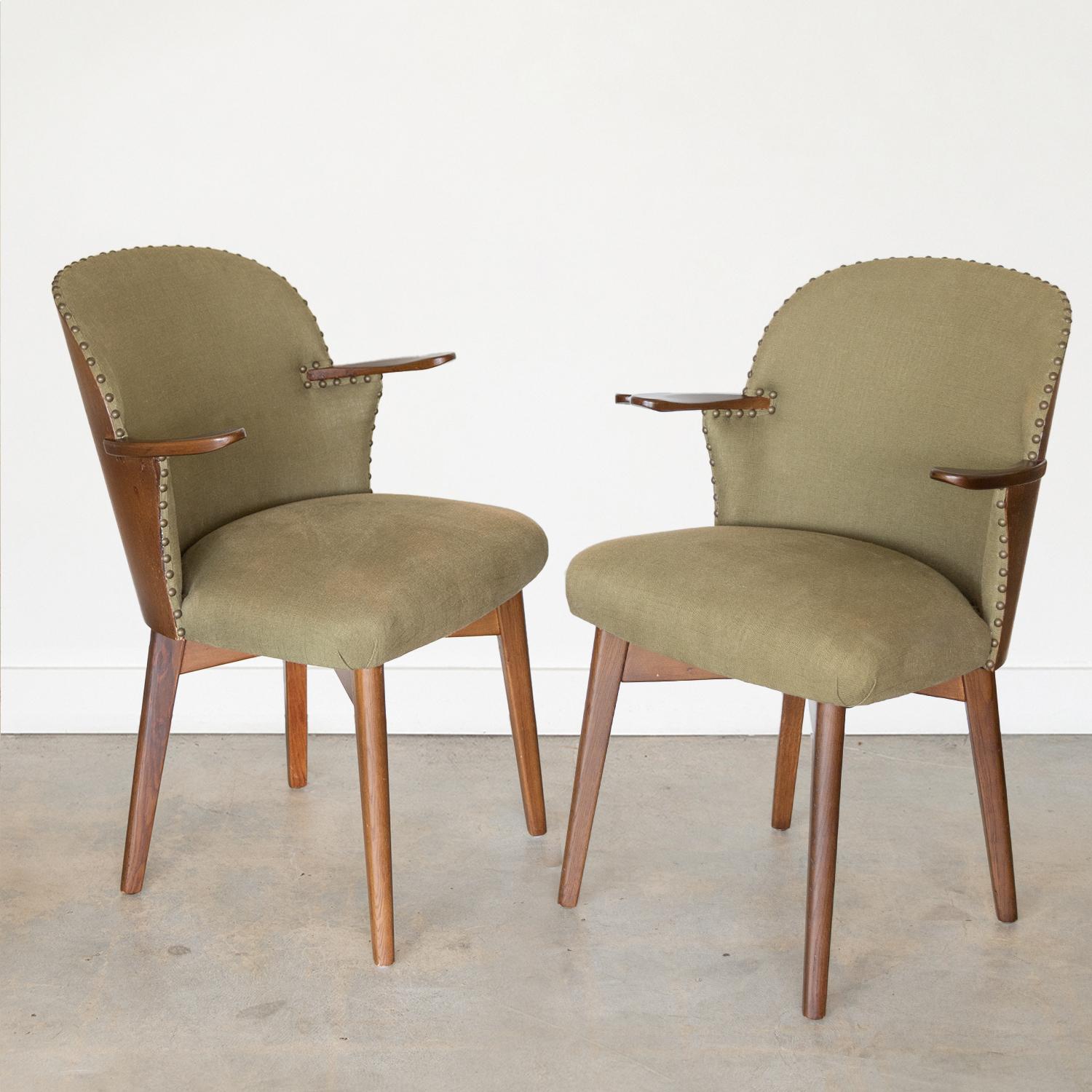 Beautiful wood back dining chairs from The Netherlands, 1960's. Curved wood veneer back with newly upholstered seat in beautiful green linen and brass tack detailing. Carved wood arms and four wood tapered legs, all newly refinished. Incredible