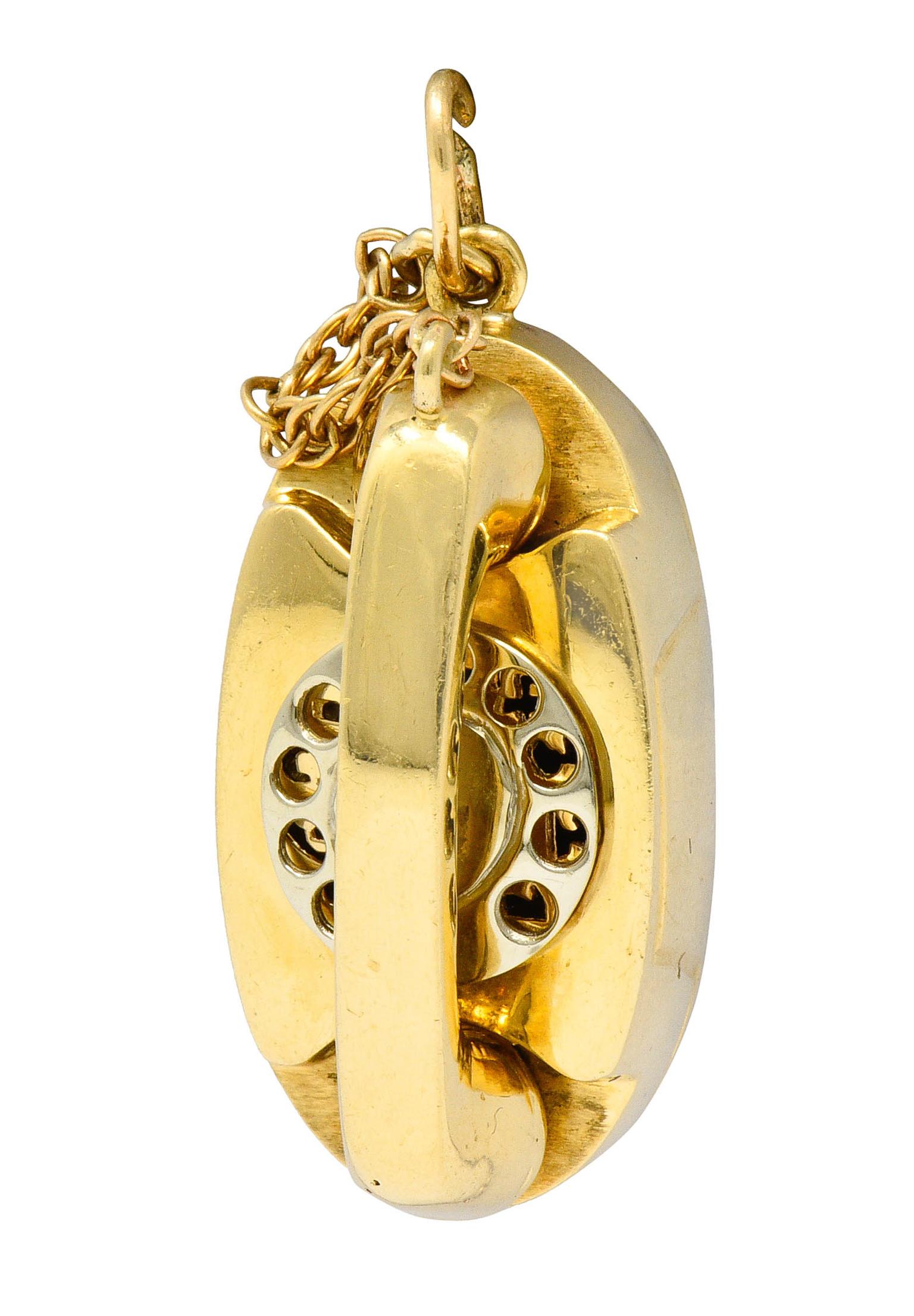 Substantial charm is designed as a vintage telephone accented by a cable chain cord

Pierced and numbered white gold rotary dial that lights up when bottom of the charm is pressed

Fully signed Litacharm Inc.

Stamped 14K for 14 karat gold

Circa: