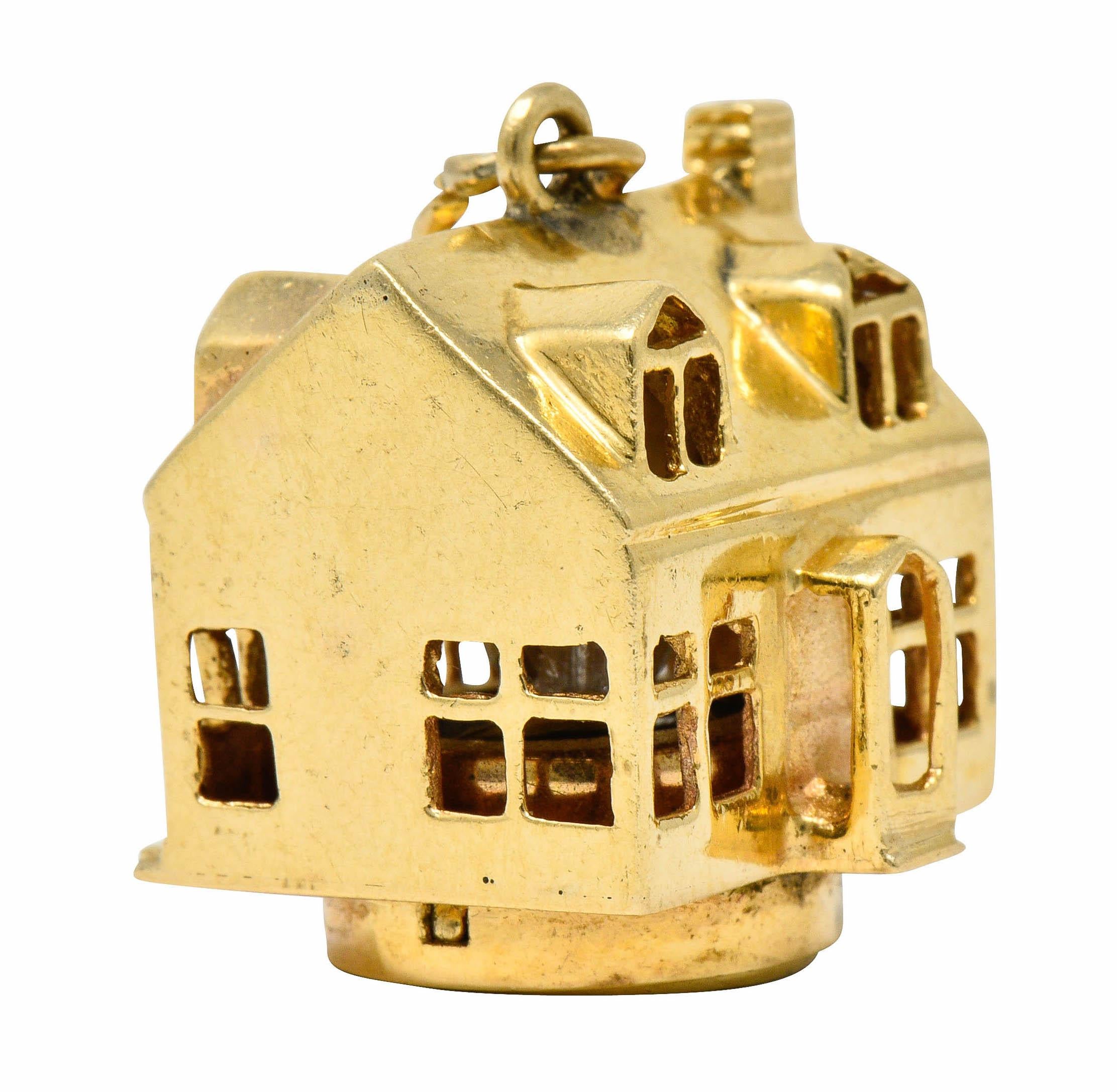 Considerable charm is designed as a house accented by a textured brick chimney

With pierced windows throughout that light up when bottom of charm is pressed
Fully signed Litacharm Inc.

Stamped 14K for 14 karat gold

Circa: 1960s