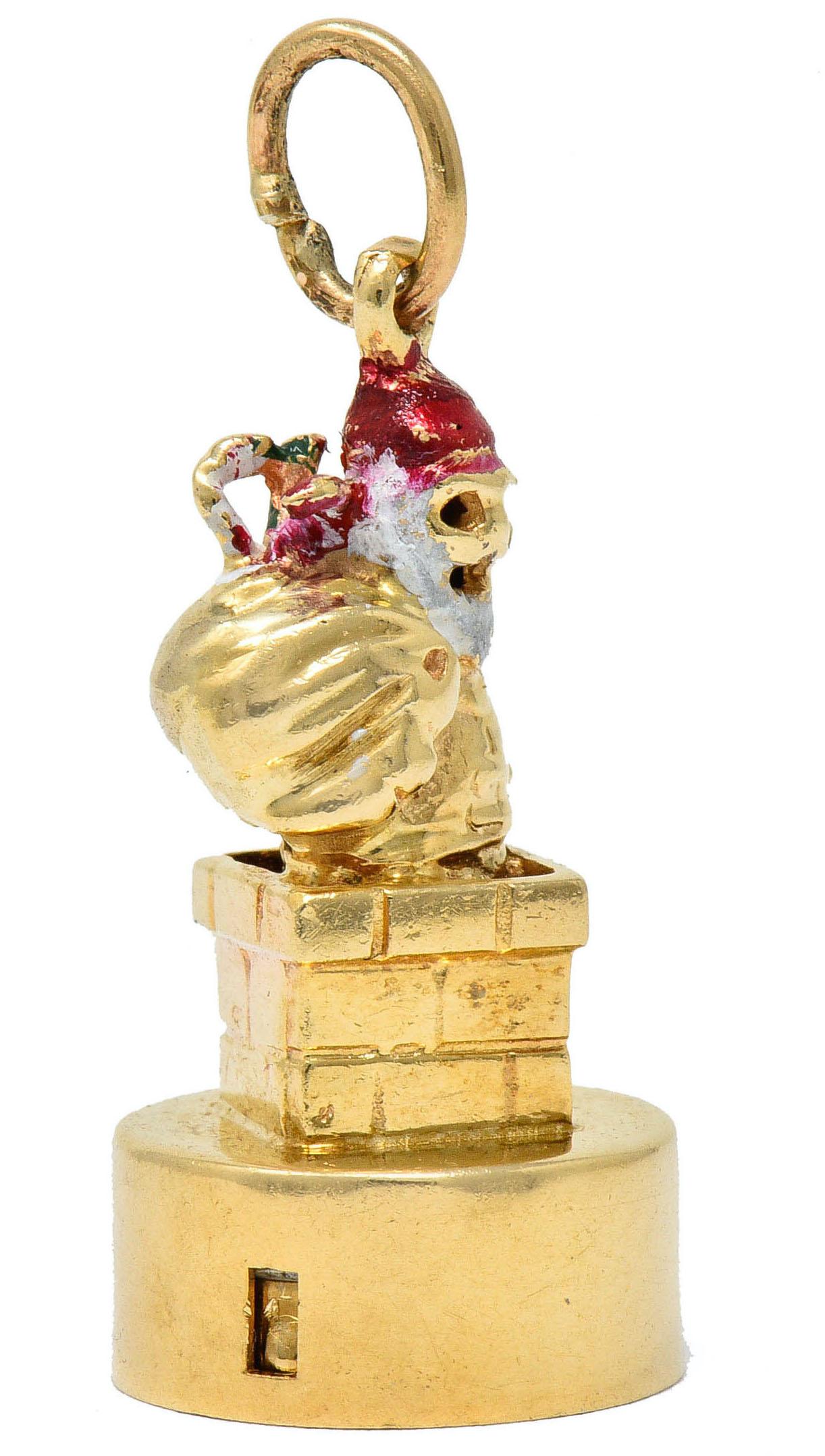 Substantial charm is designed as Santa Claus with a rusack over his shoulder

Beard and hat are glossed white and red with enamel; exhibiting some loss

Face lights up when bottom of charm is pressed

Pedestal is designed as a chimney with deeply