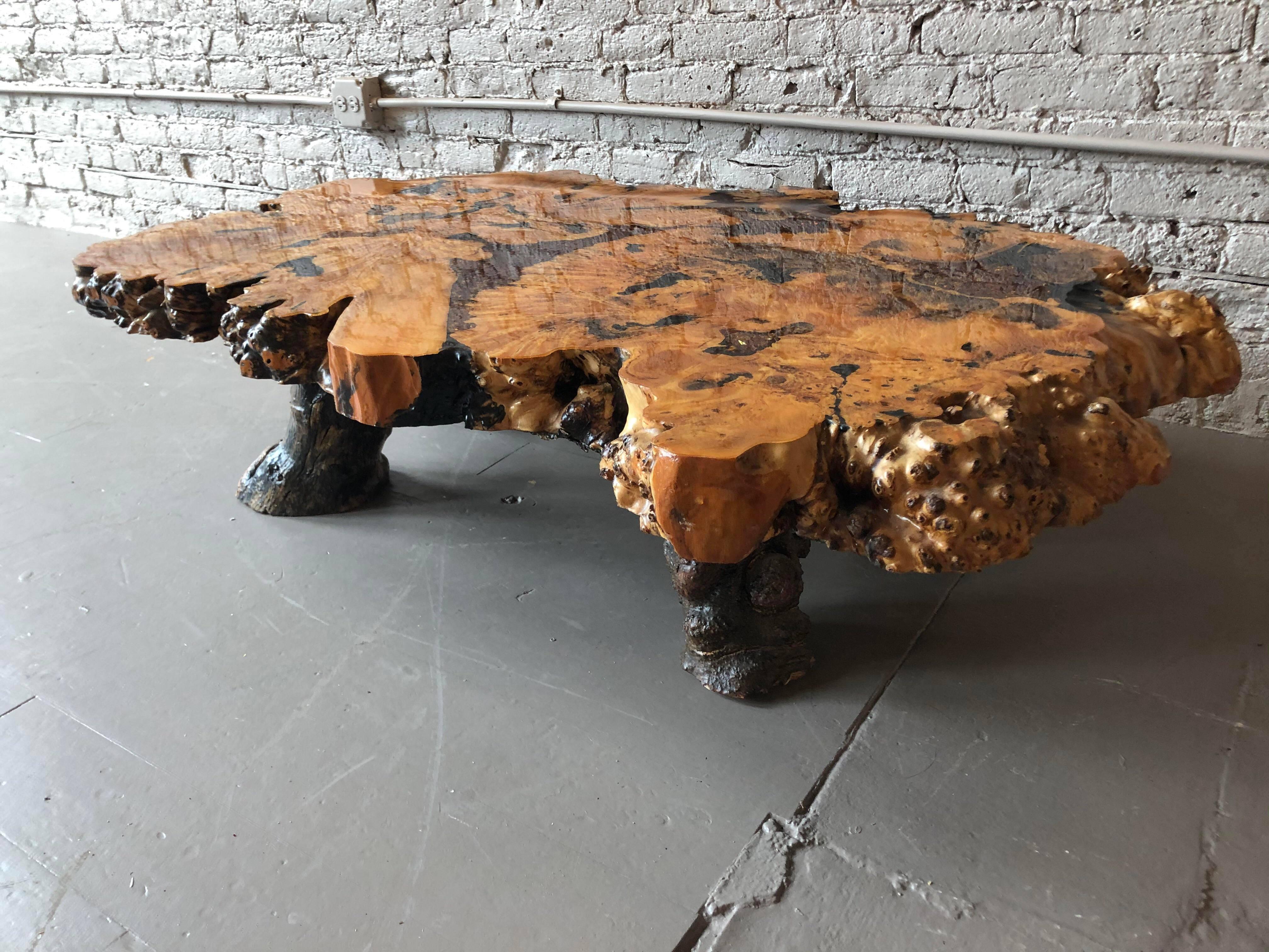 Statement piece. The table has a beautiful epoxy finish with brown crystals in btwn some of the wood. The wood and finish are in excellent condition.

Dimensions: 56