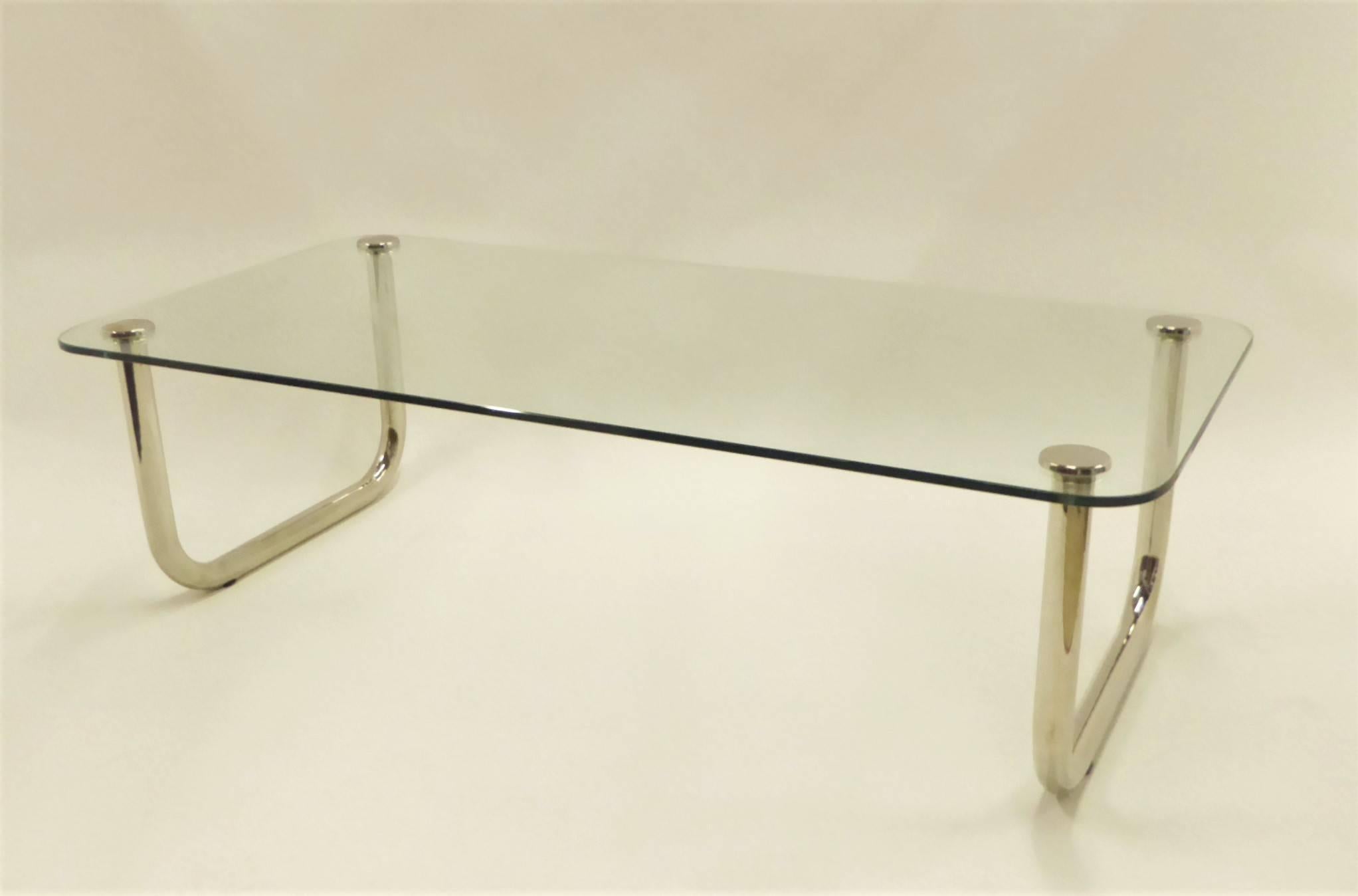 Great scale and fat tubular legs in the style of John Mascheroni with curving nickelled sled legs highlight this rarely seen late 1960s coffee cocktail table with a floating 1/2 inch glass top. Legs re-nickelled, new glass. Fabulous