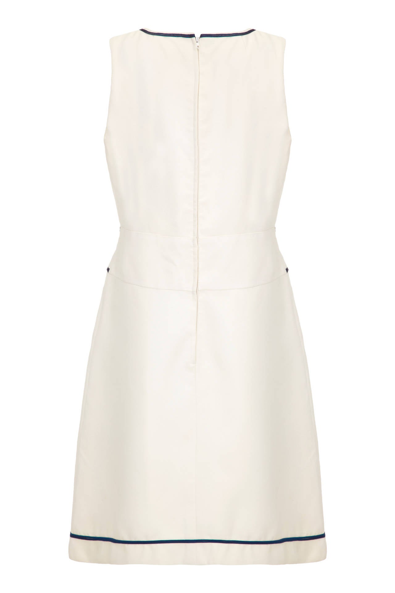 This desirable 1960s off-white mini dress by Louis Feraud for Rembrandt is in pristine vintage condition and superbly adaptable with a smart contemporary aesthetic. Made of thick nylon crepe fabric, the dress is sleeveless, tailored snugly over the