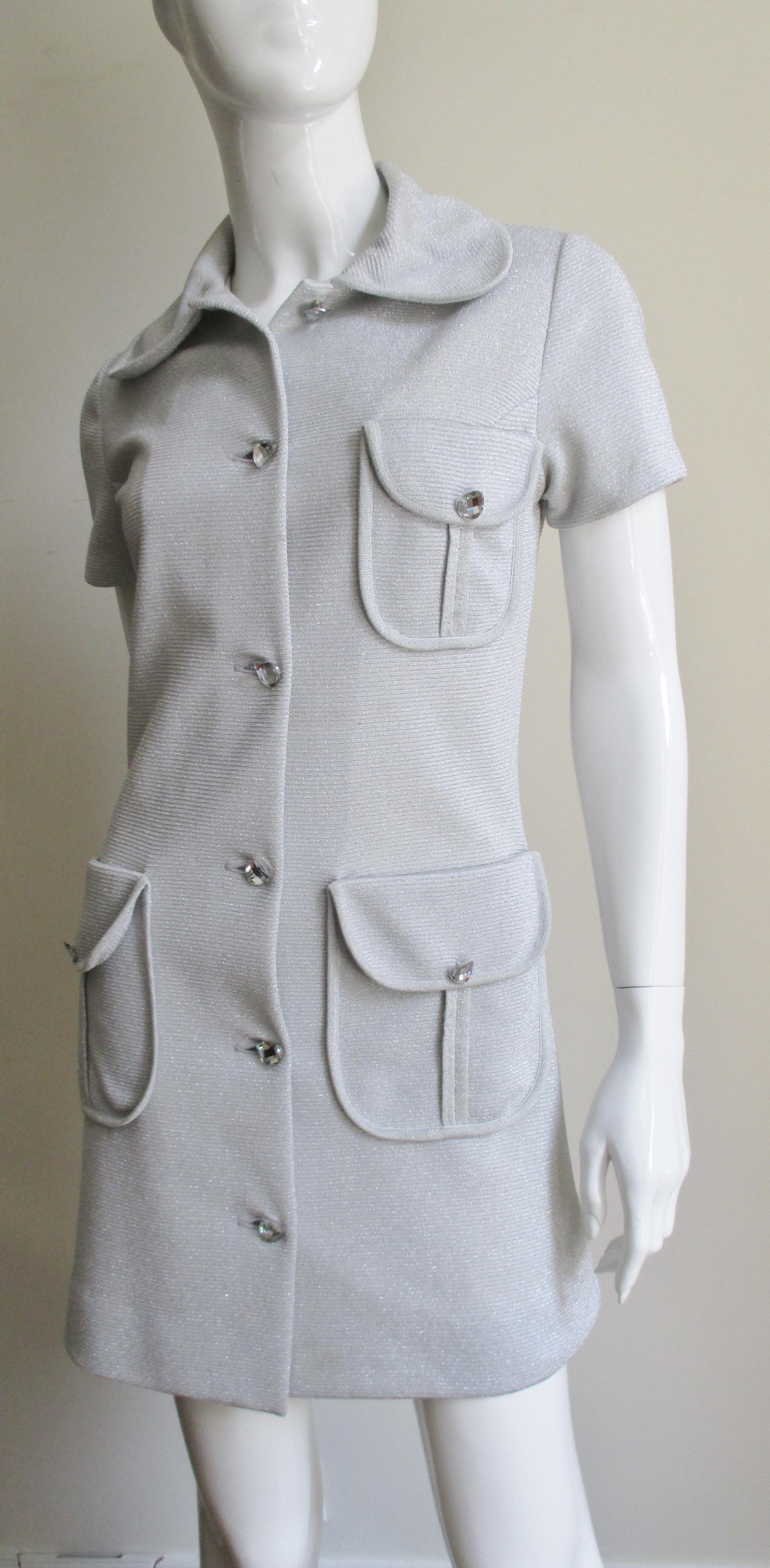A great 1960s silver lurex mini dress from Louis Feraud. The short sleeved dress simple shirtwaist style dress has a peter pan collar, 3 button flap patch pockets and 6 center front faceted mirror glass buttons. It is unlined.
Fits Extra Small,