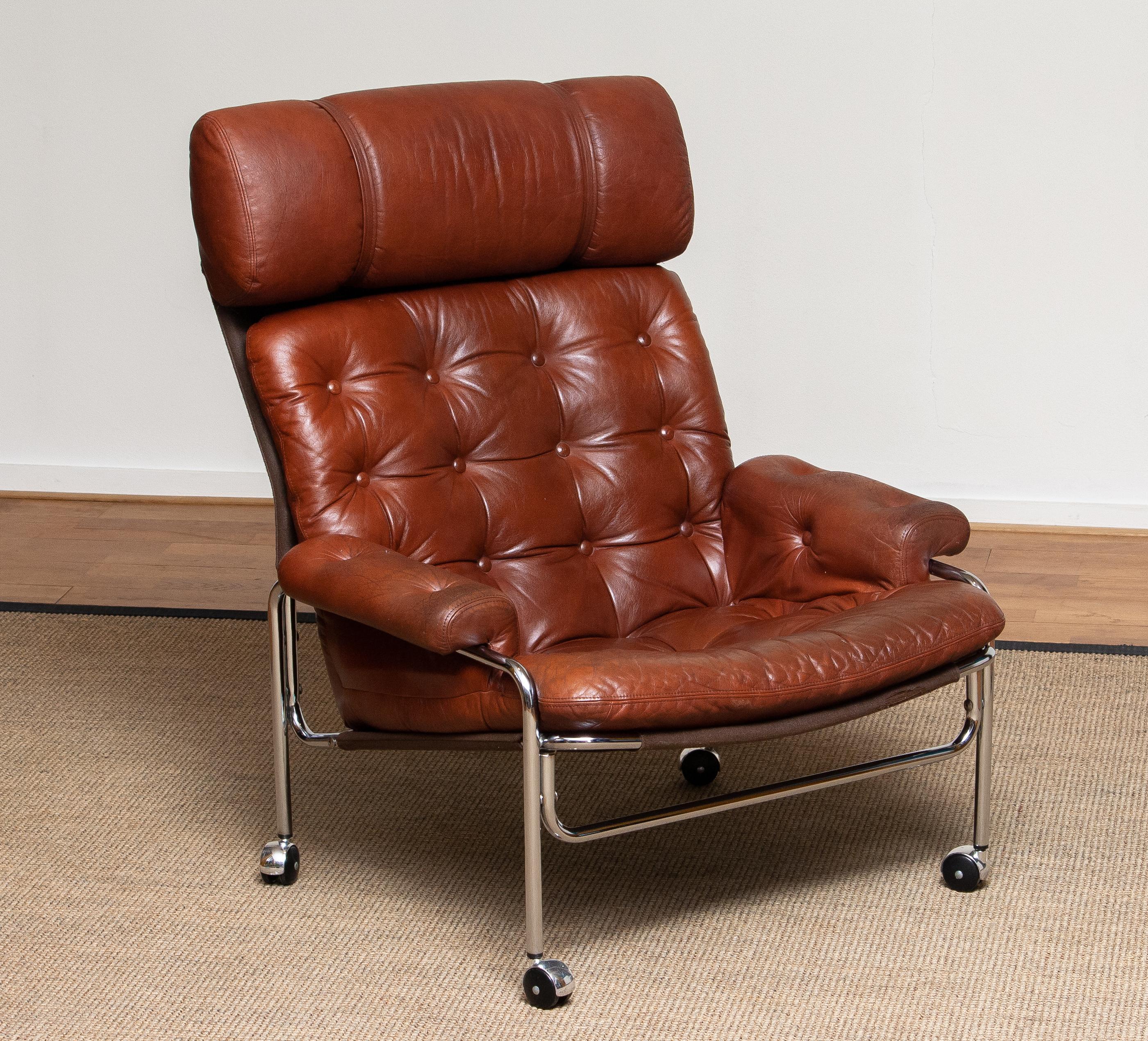 Beautiful lounge / easy chair in aged brown / cognac leather and chrome designed by Pethrus Lindlöfs for A.B. Lindlöfs Möbler Lammhult, Sweden.
The aged leather on the chairs gives the chairs the typical vintage character. The leather is soft and